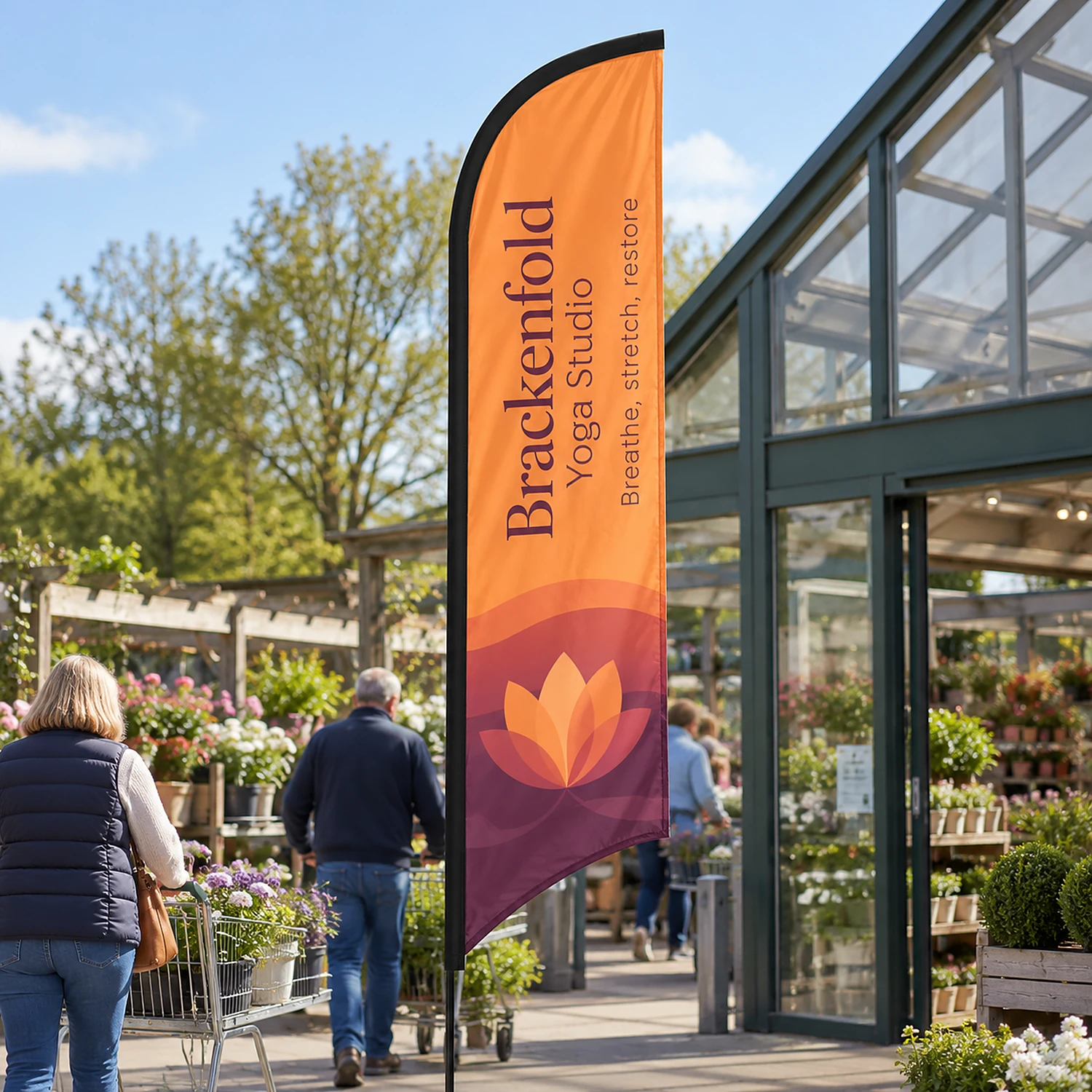 Blade Flag 10ft at a garden centre entrance, shown with an example design