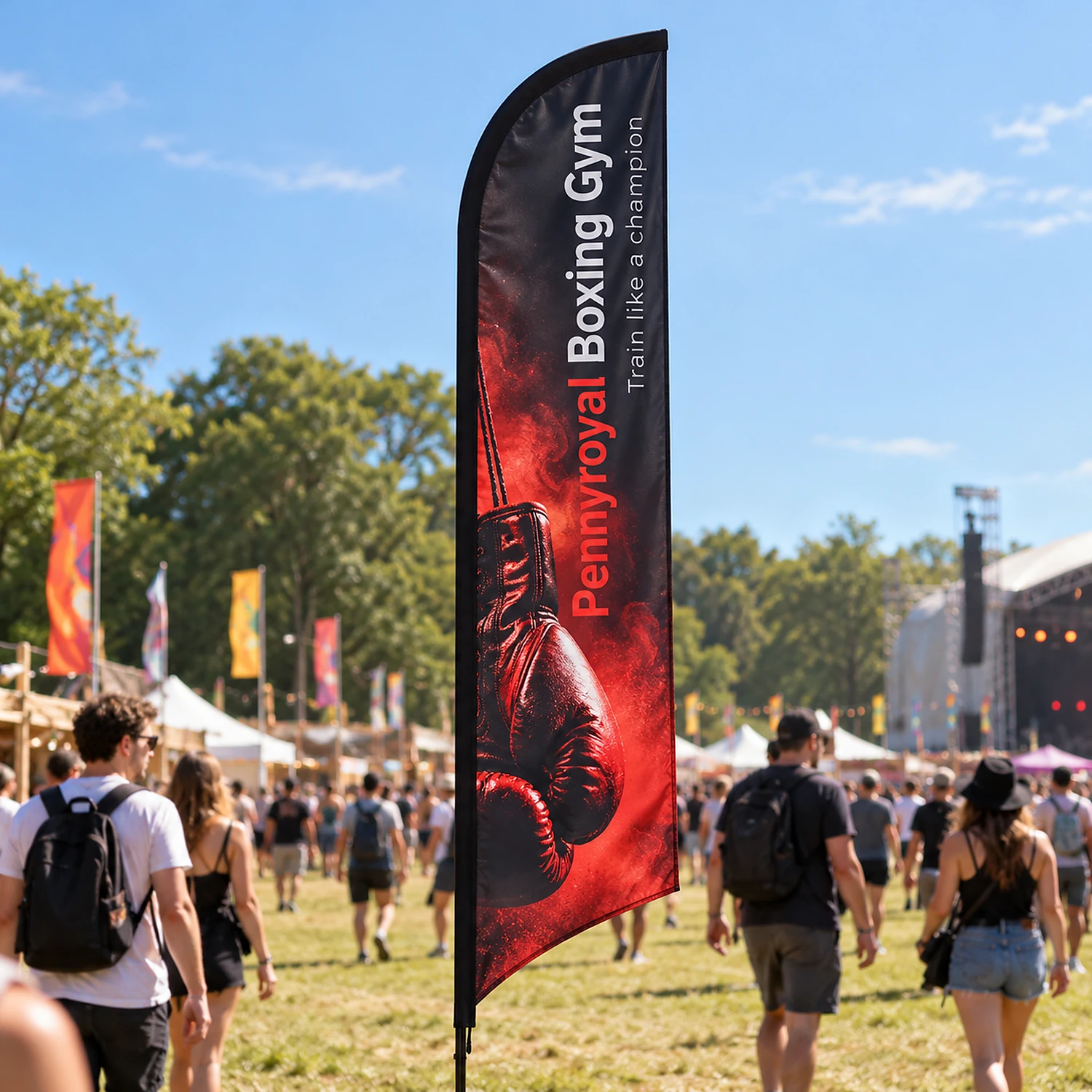 Blade Flag 10ft at an outdoor summer festival, shown with an example design