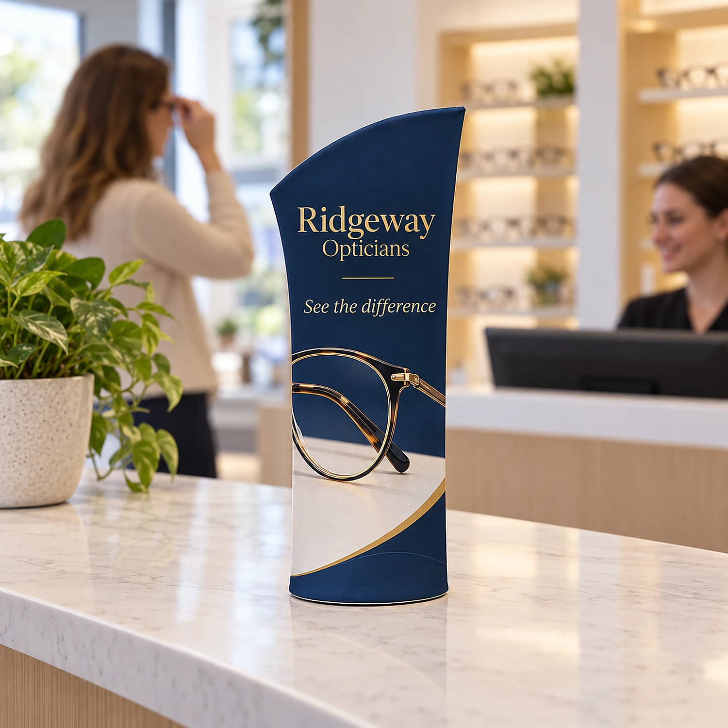Brandcusi Bambino tabletop banner stand on a shop reception desk