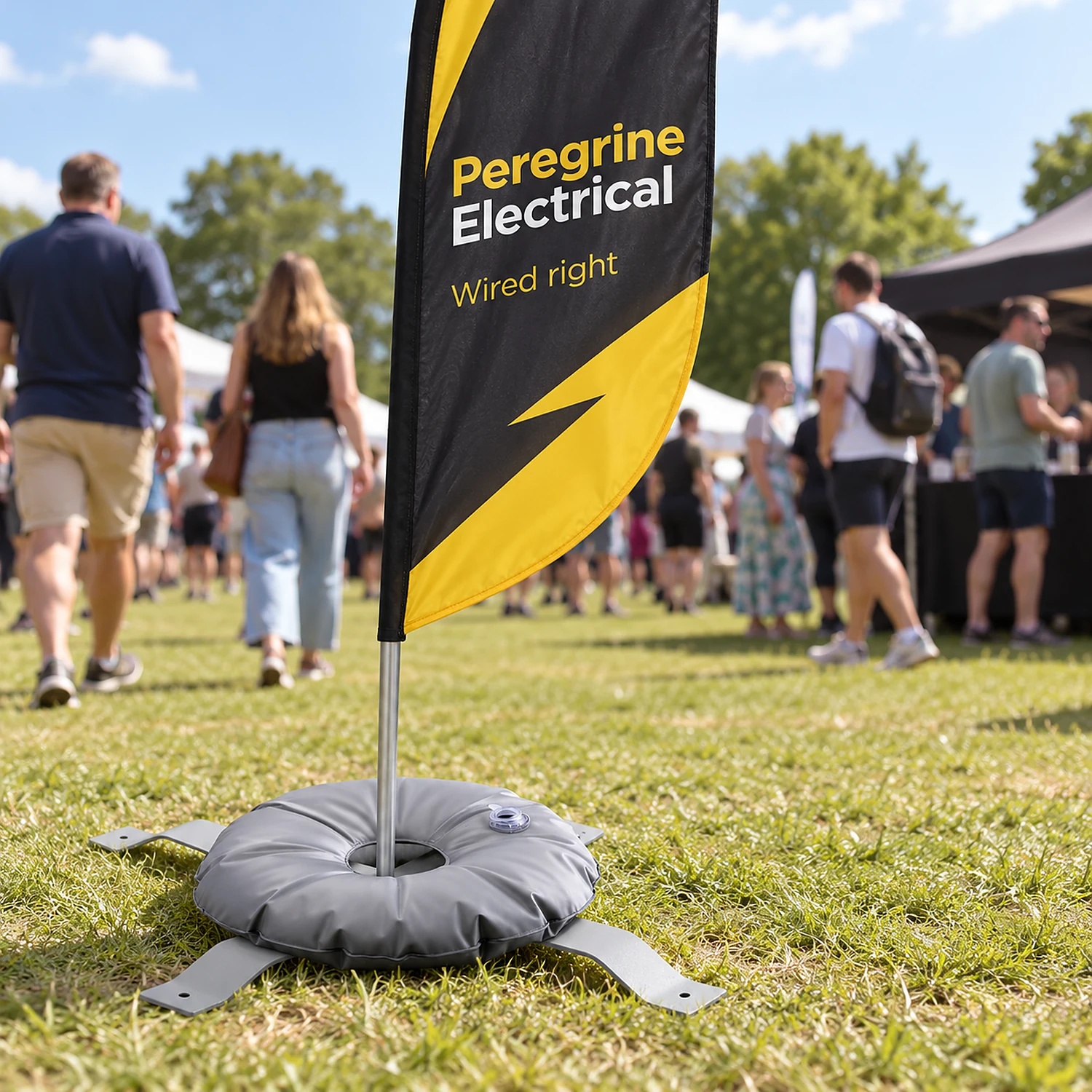 Cross base and weighting ring holding a flag at an outdoor event