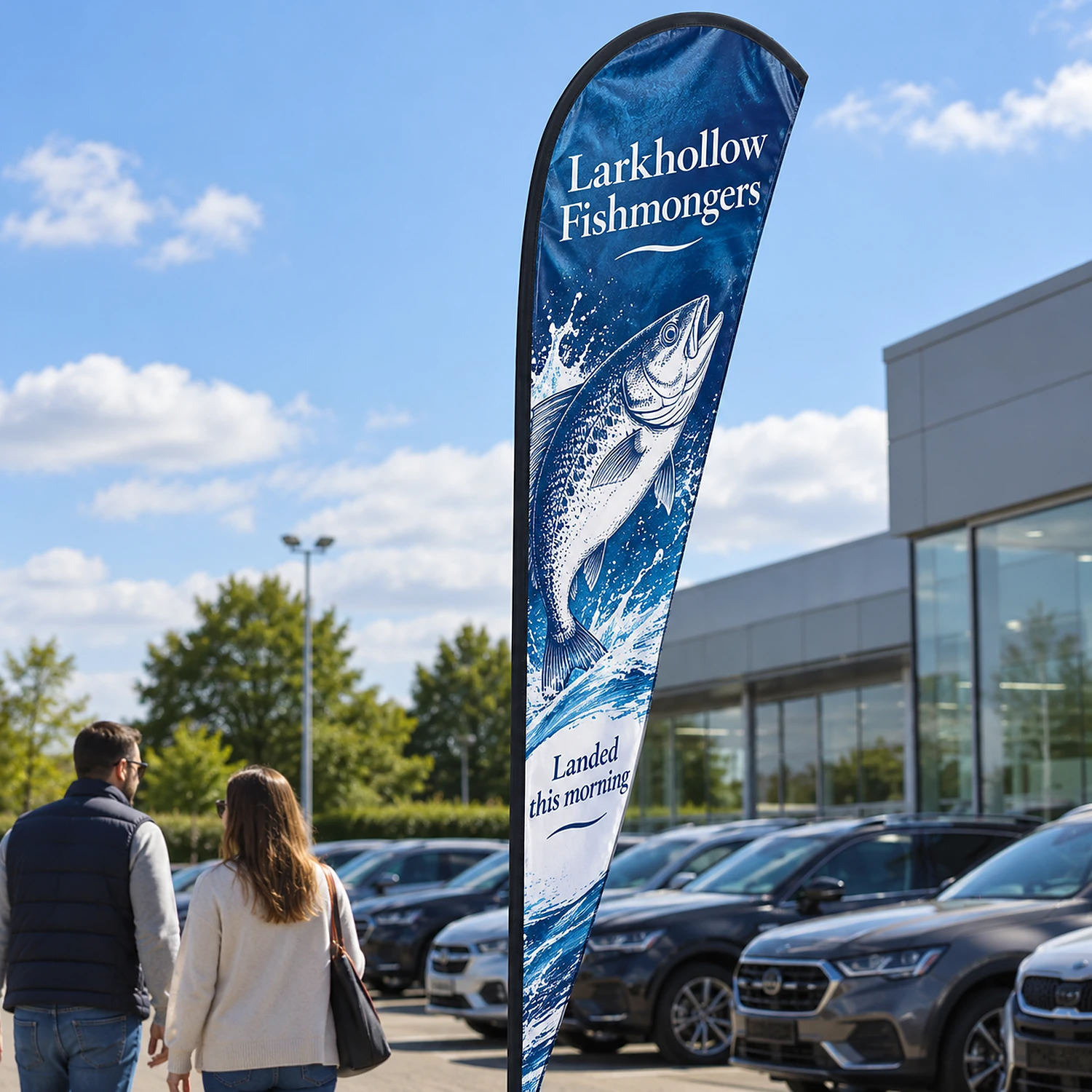 Feather Flag 14ft on a car dealership forecourt, shown with an example design