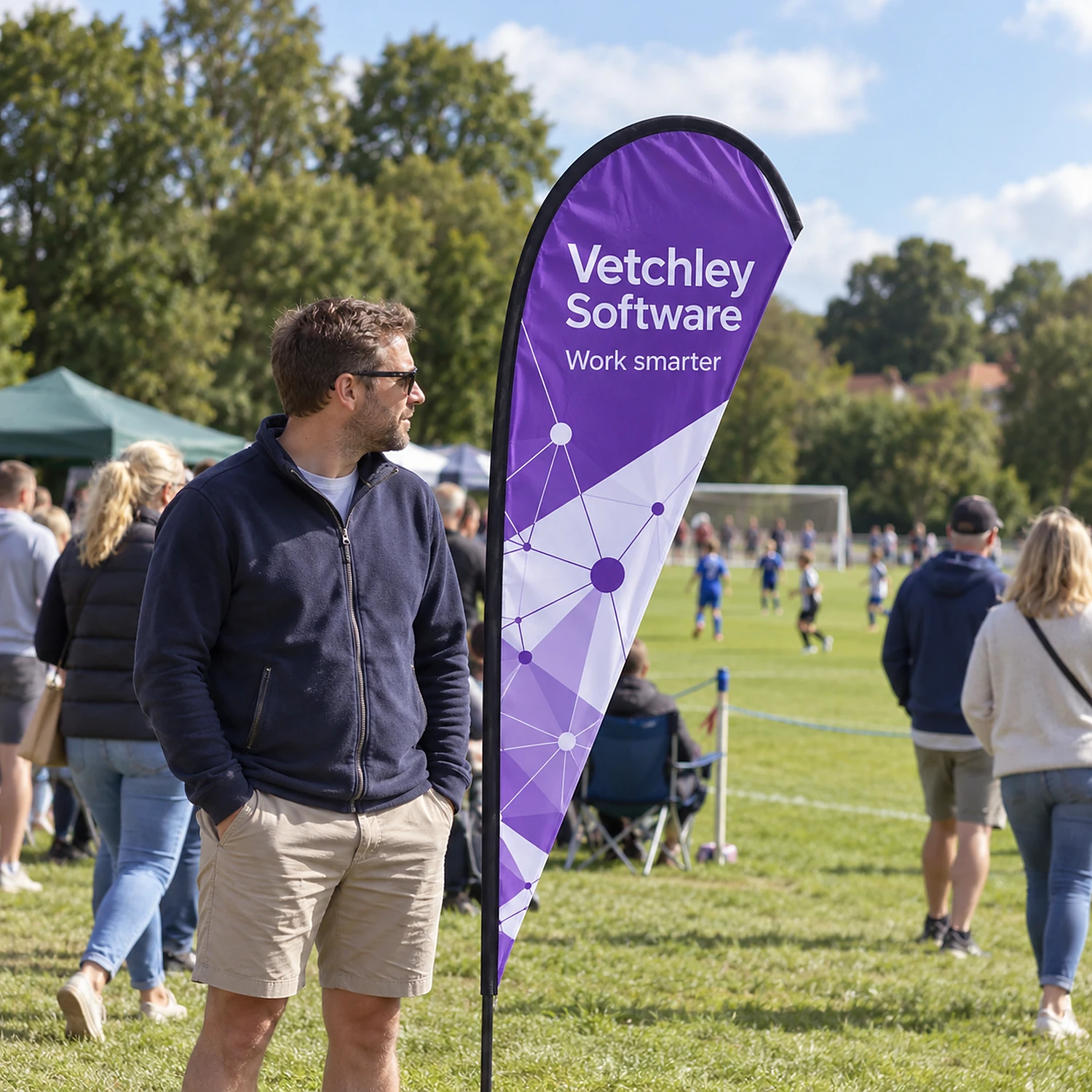 Feather Flag 7ft at a community sports day, shown with an example design