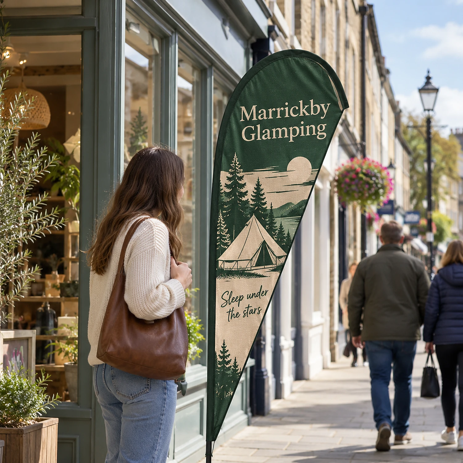 Feather Flag 7ft outside a shop on a high street, shown with an example design