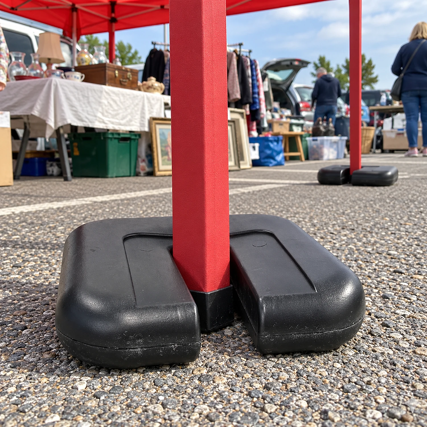 Gazebo leg weights holding down a gazebo at a market