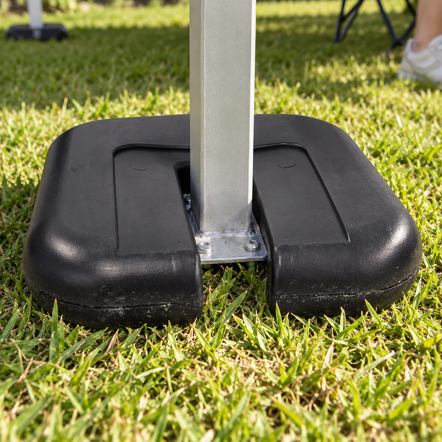 Close view of a gazebo leg weight fitted around a leg