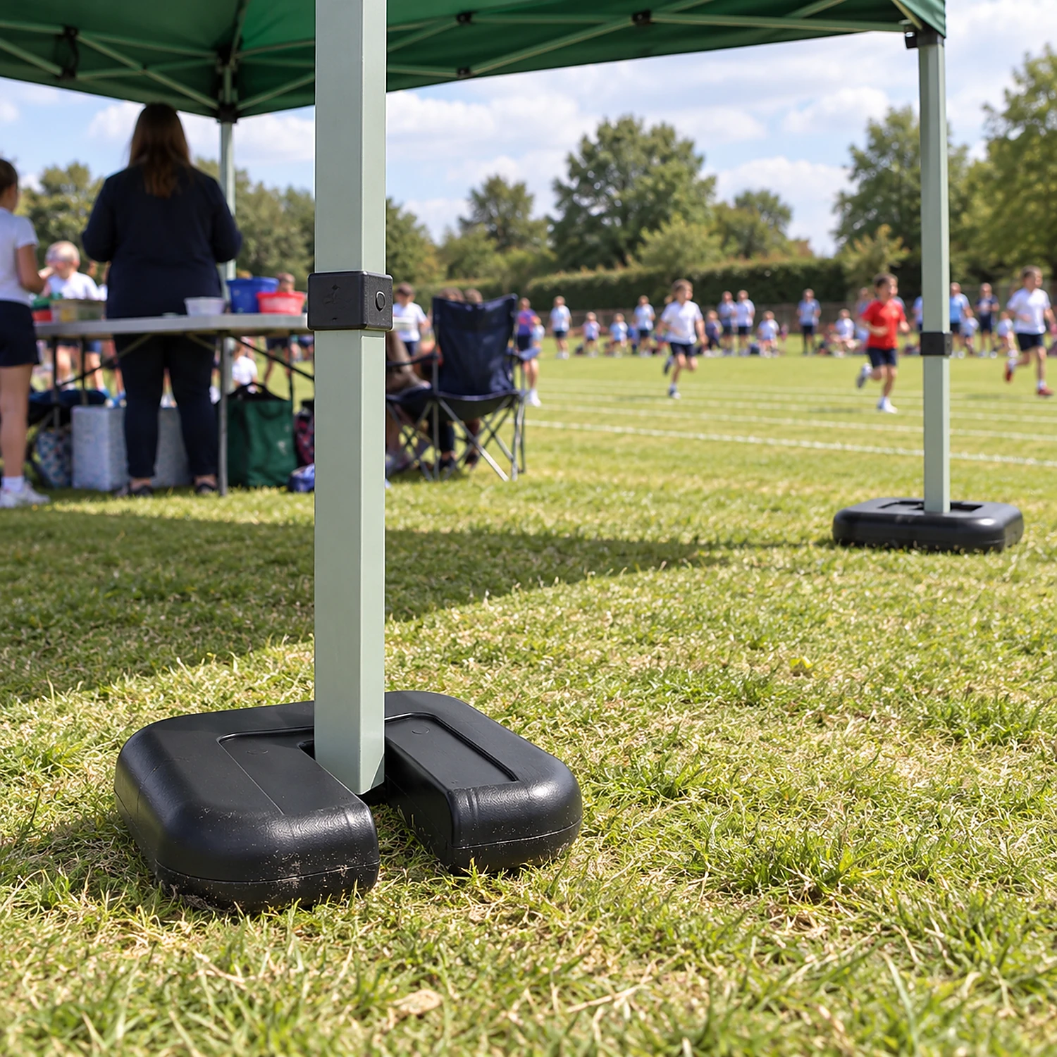 Gazebo leg weights in use at a sports day