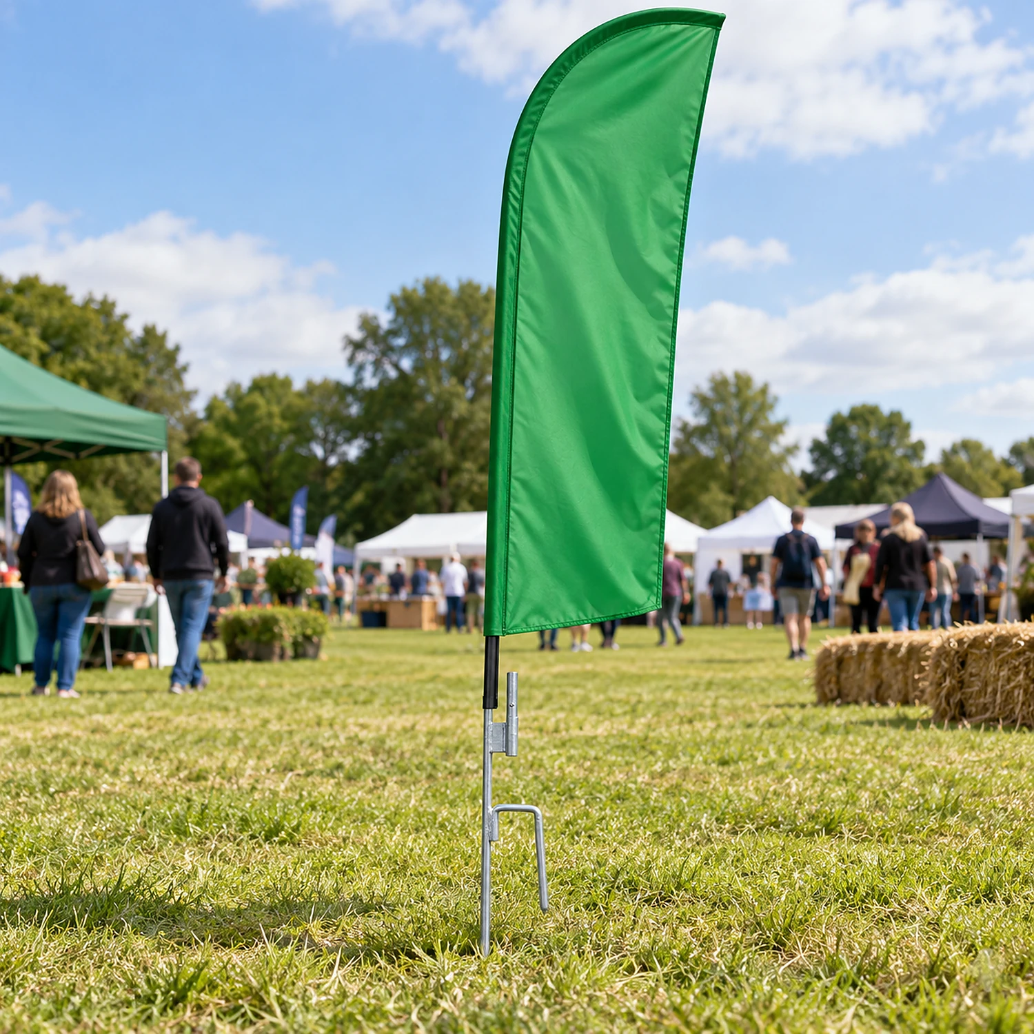 Ground spike holding a feather flag pole in grass
