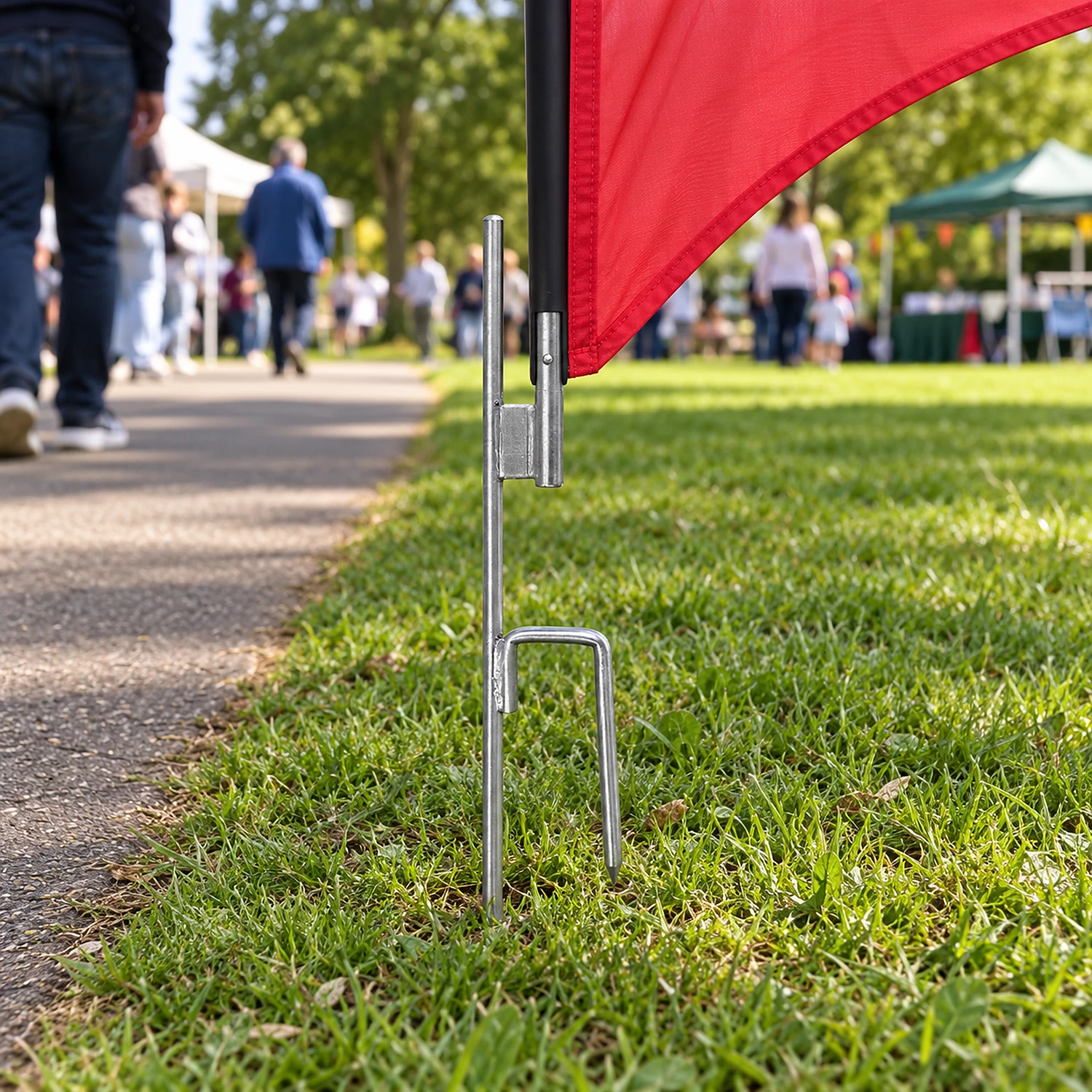 Ground spike flag base in use in a park