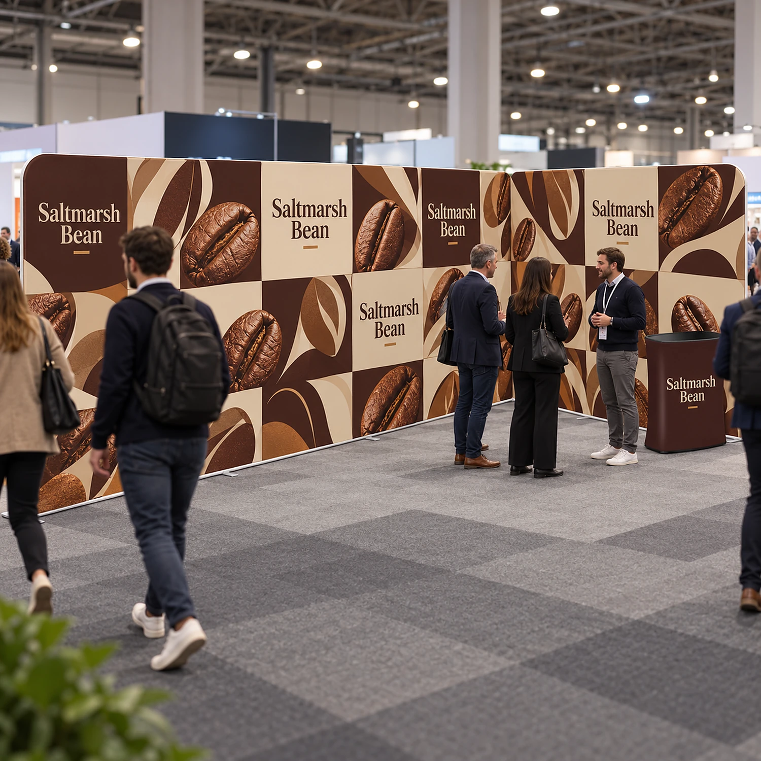 L-shaped fabric exhibition stand with counter in use at a busy trade show