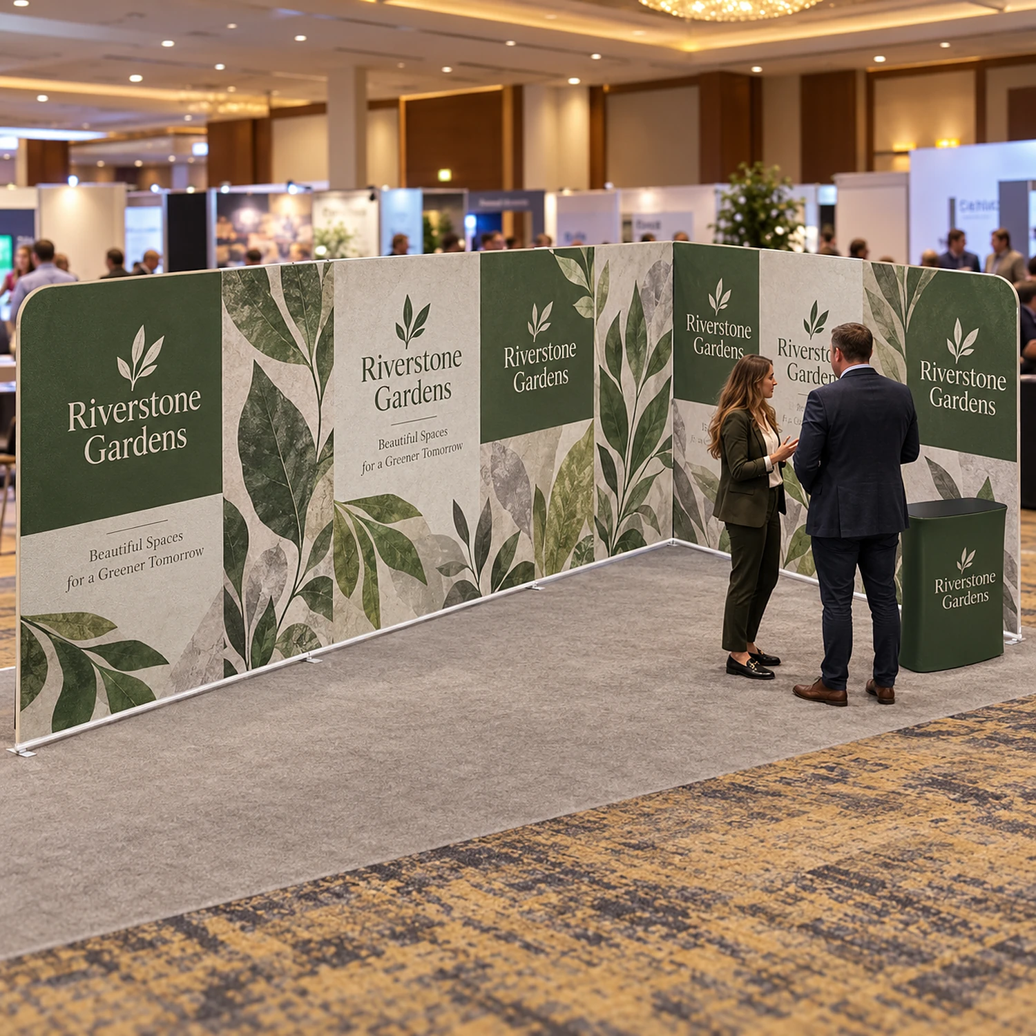 L-shaped fabric exhibition stand with counter at a business expo with staff talking to a visitor