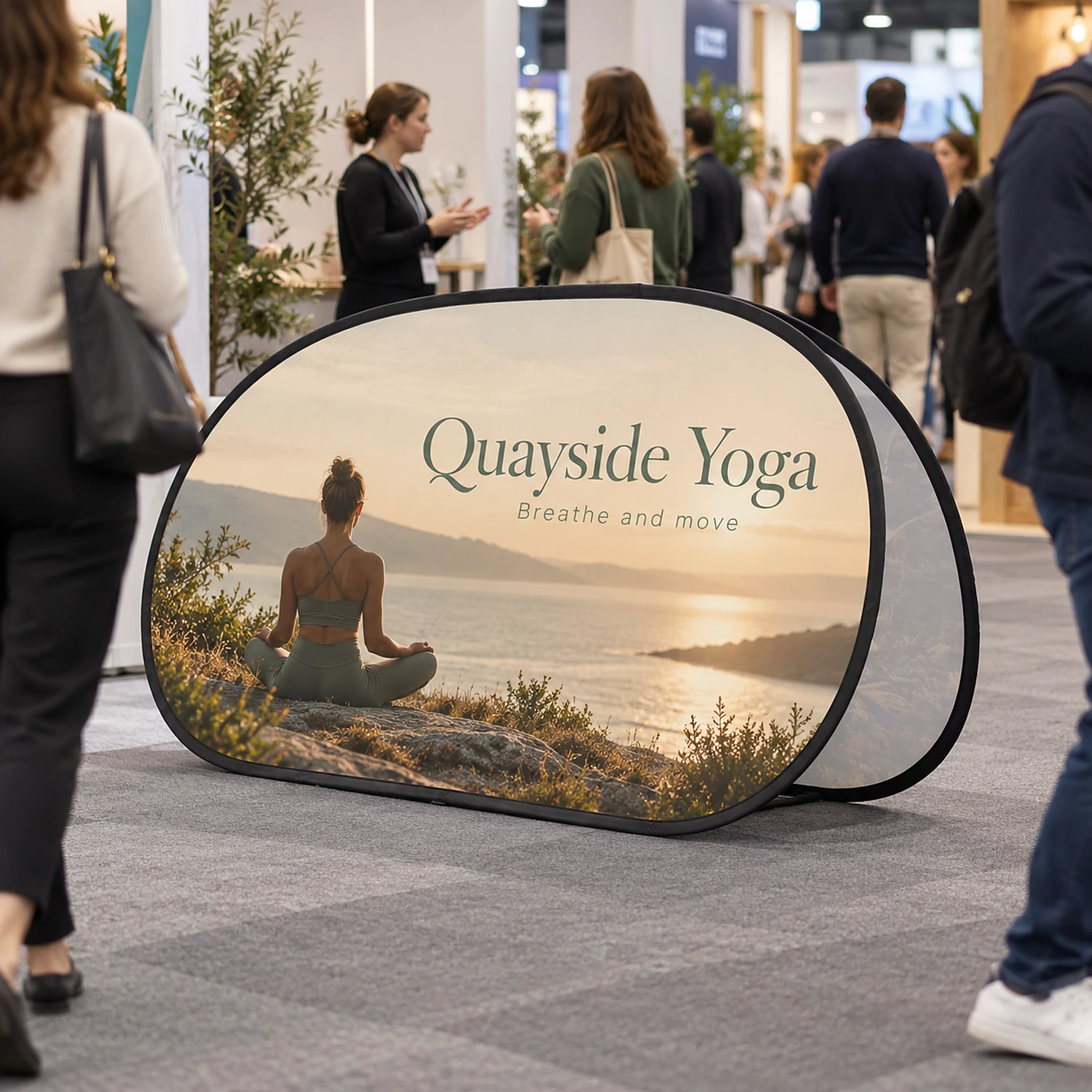 Oval pop-out banner in use at a busy trade show