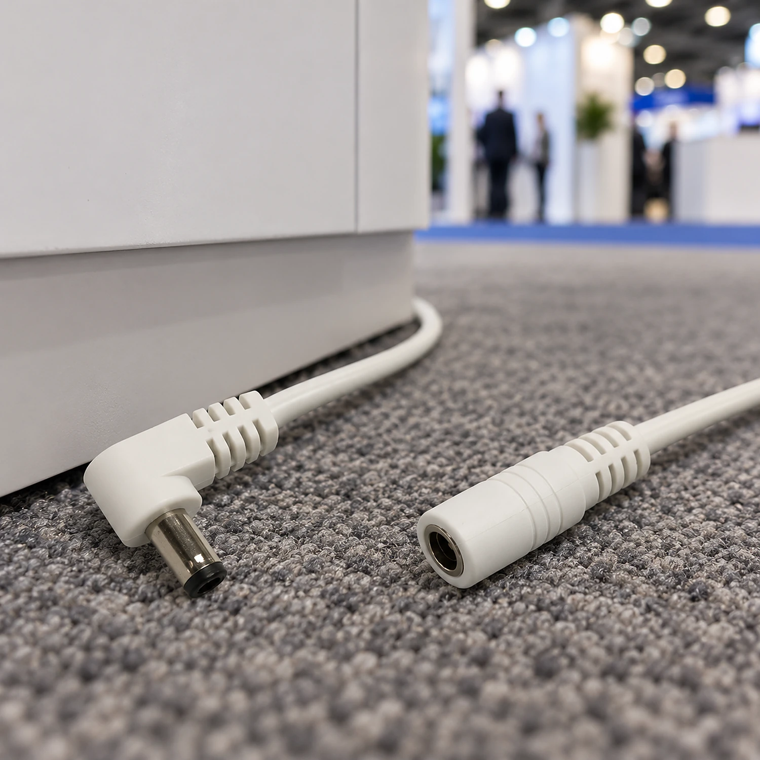 Power extension cable run along a stand floor