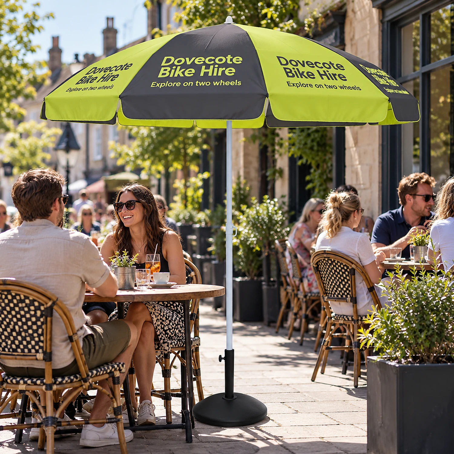 Printed promotional parasol in use on a cafe terrace