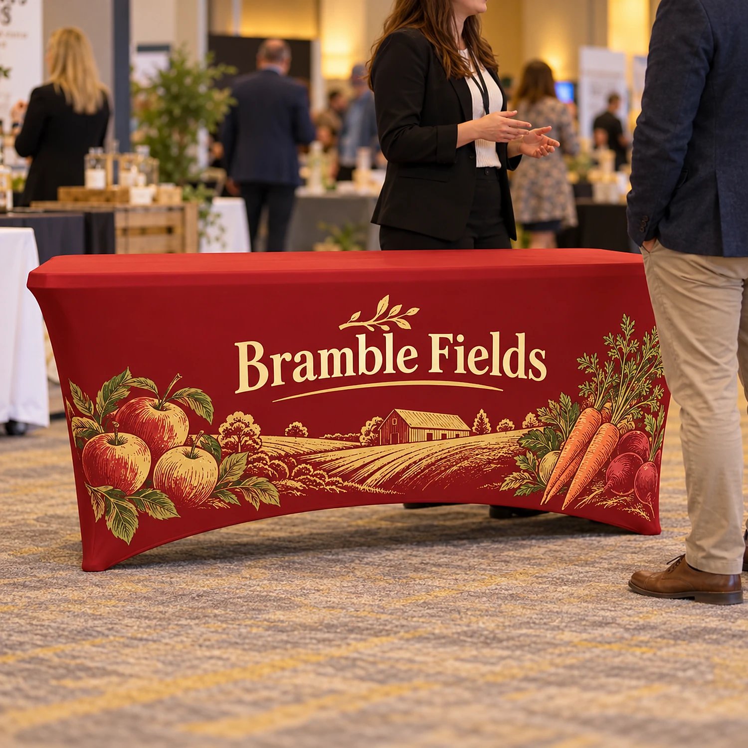 Printed stretch tablecloth at a business expo with staff talking to a visitor