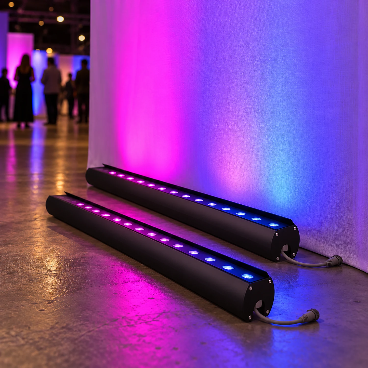 Pair of RGB light bars washing a fabric wall with colour