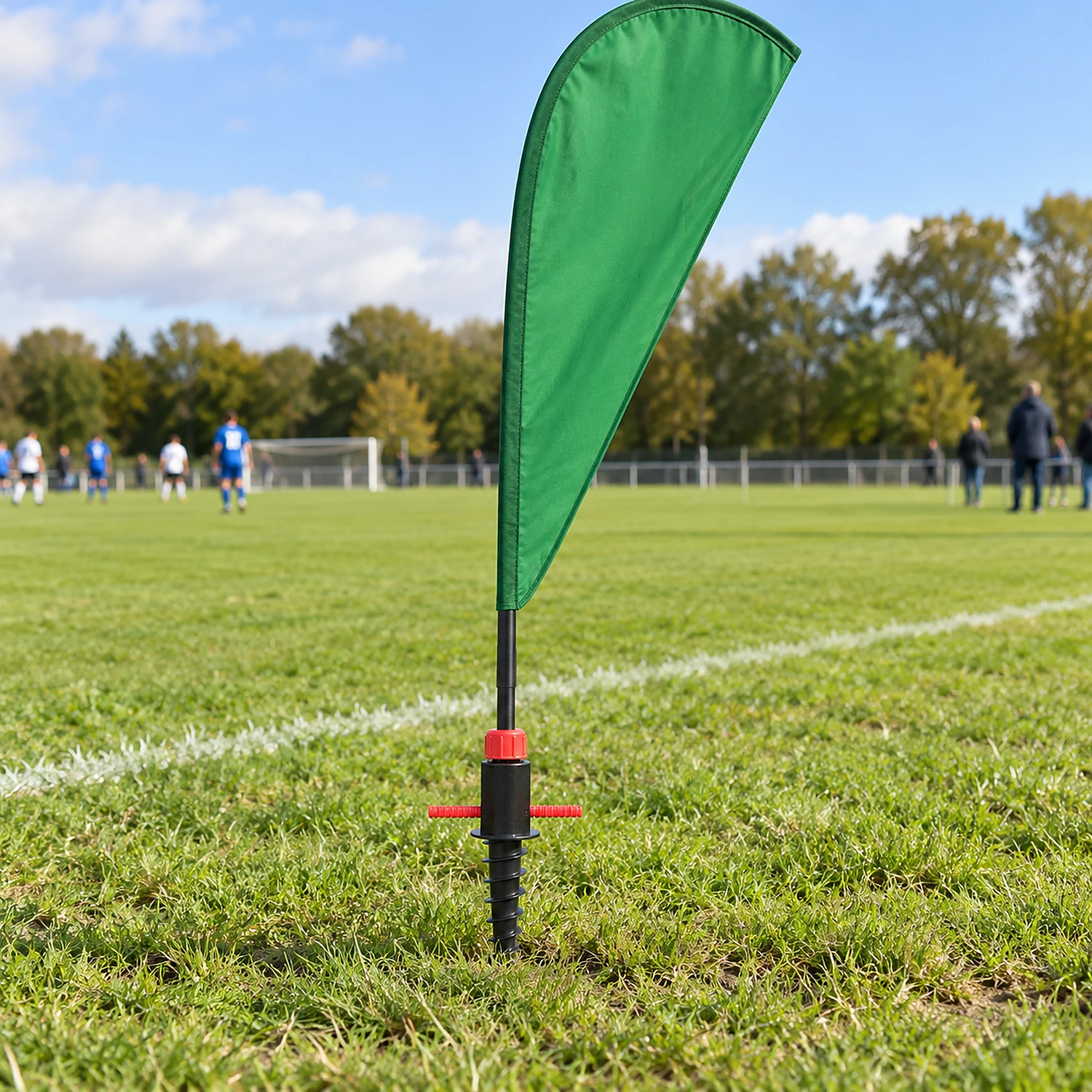 Screw spike flag base beside a sports pitch