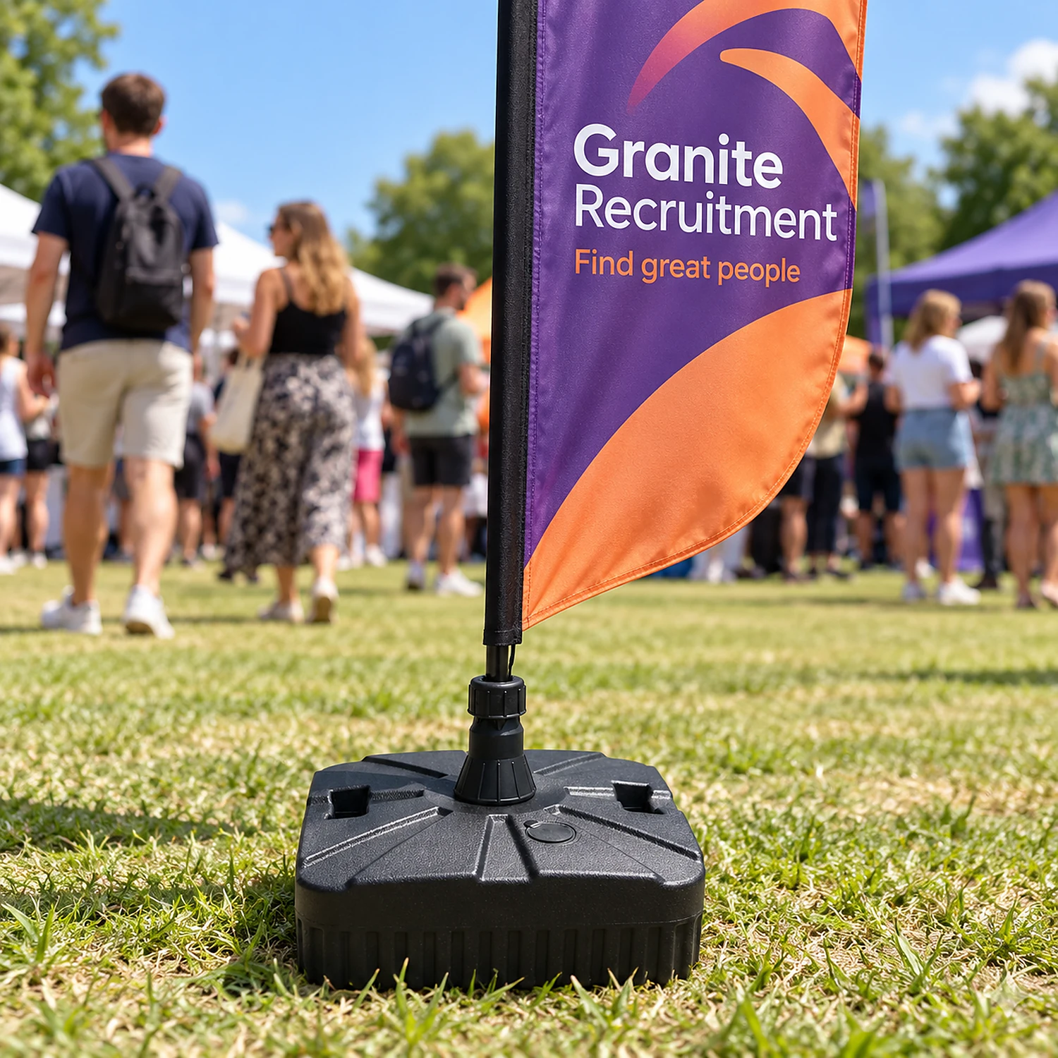 Small water sand base holding a flag at an outdoor event