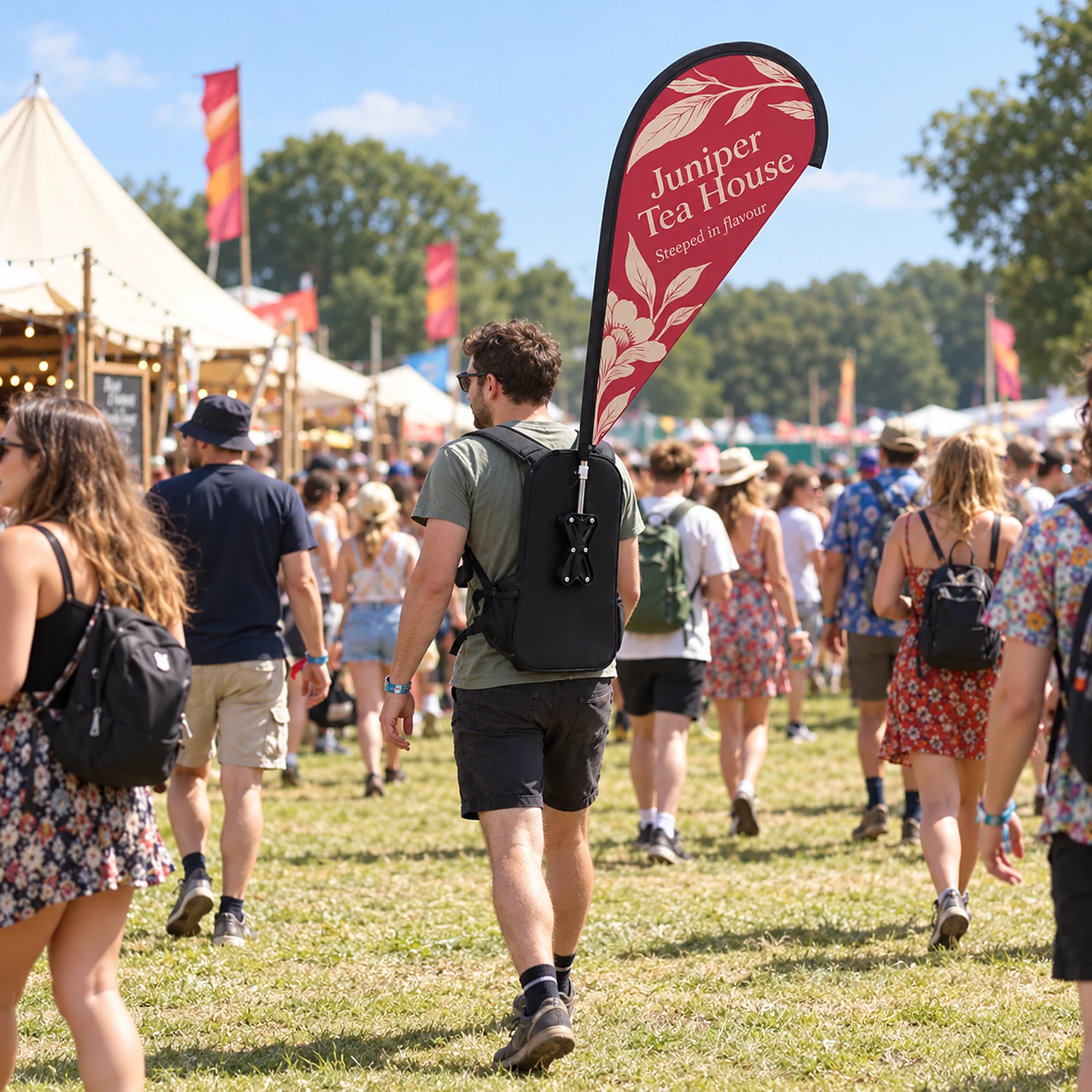 Teardrop backpack flag worn at a summer festival