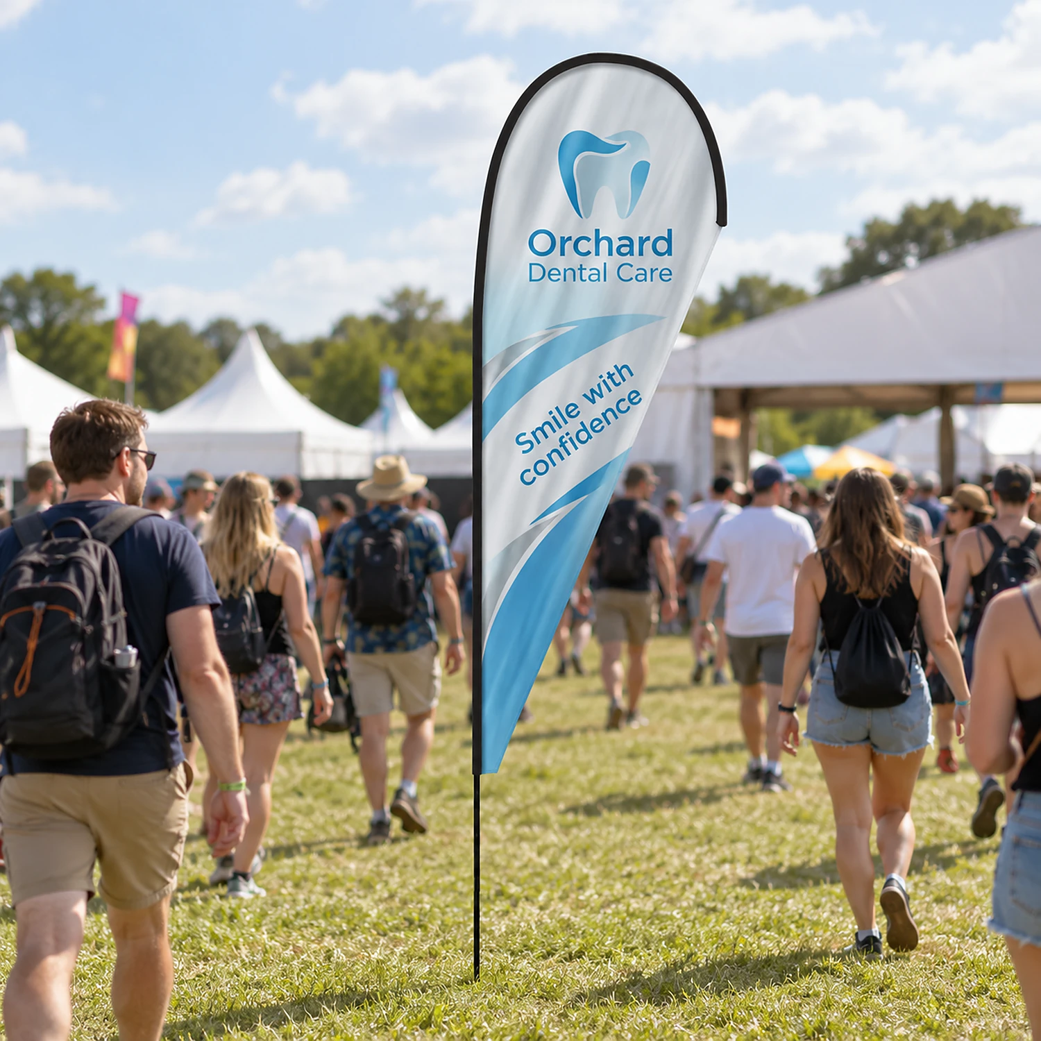 Teardrop fibreglass flag in use at a summer festival entrance