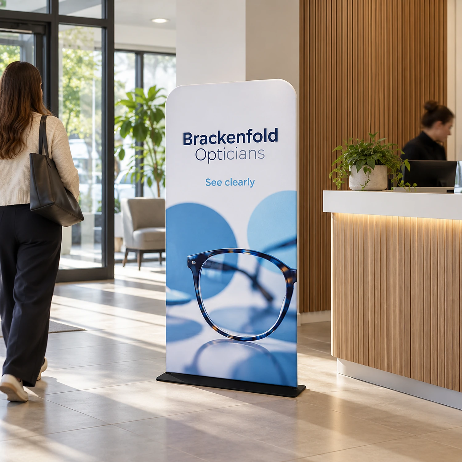 913mm x 1524mm rounded-corner tension banner stand in use, shown with an example design