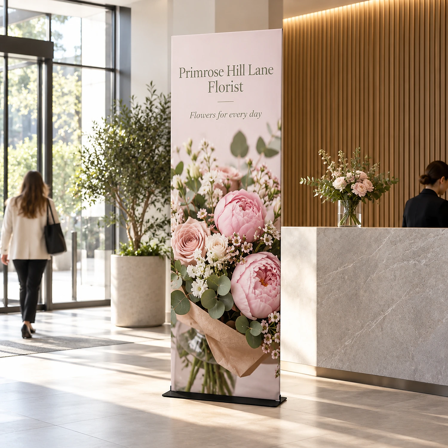 913mm x 2950mm square-corner tension banner stand in use, shown with an example design