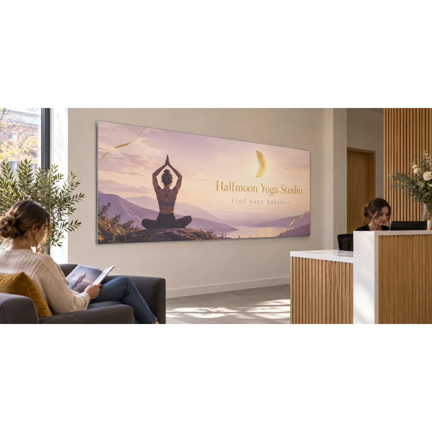 Wall mounted tension fabric display frame in an office reception, shown with an example design