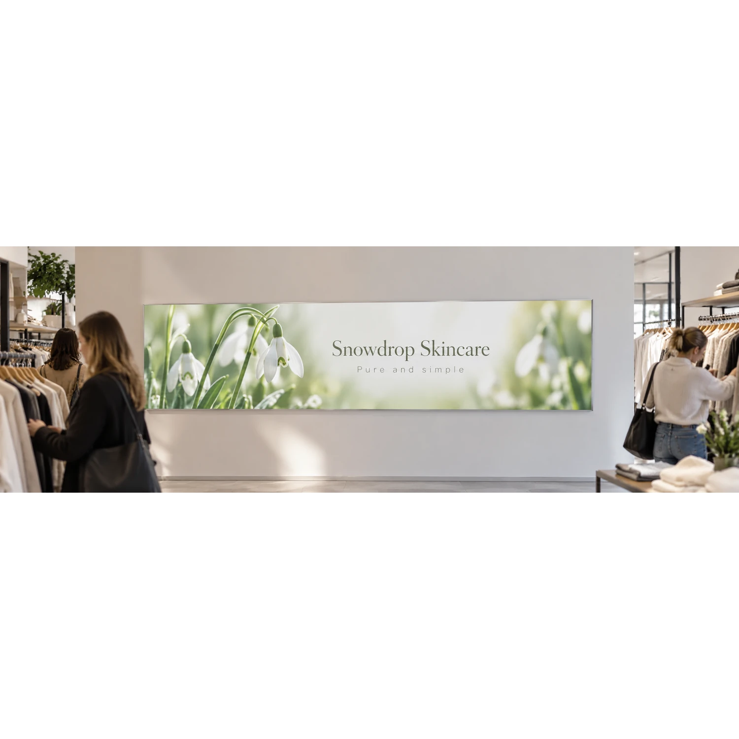 Wall mounted tension fabric display frame in a retail store, shown with an example design