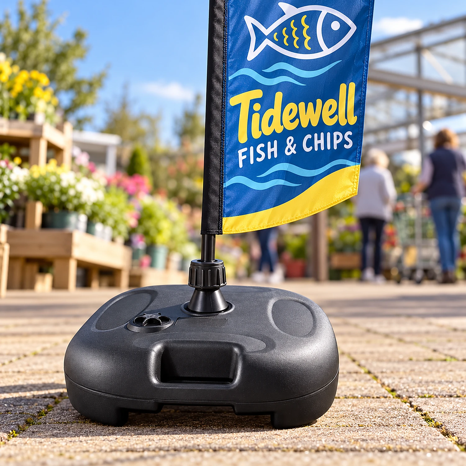 Water base holding a small feather flag on a garden centre forecourt
