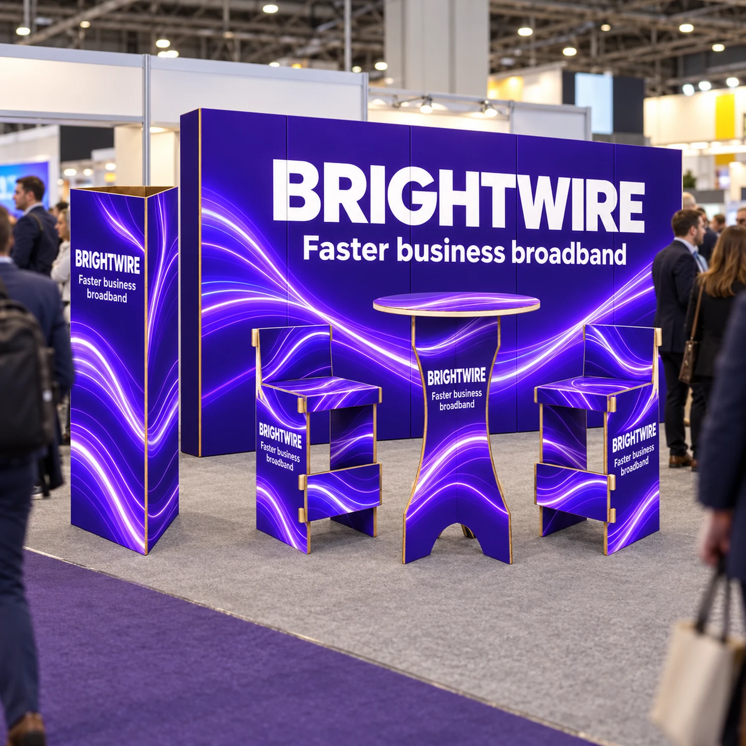 3m x 3m Cardboard Networking Stand Kit - 2.67m Wall, Poseur Table, Two Bar Stools & Triangle Totem in use at a trade show, shown with an example design
