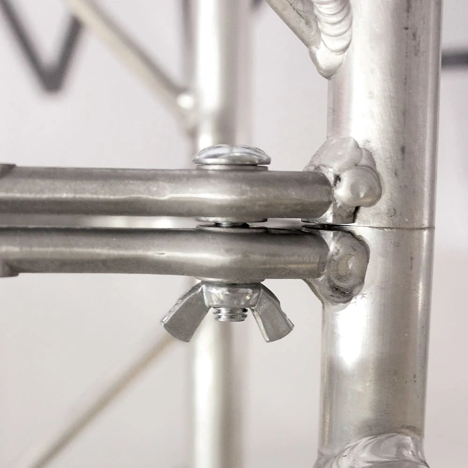 Close-up of the bolt and wing nut joining truss connection lugs