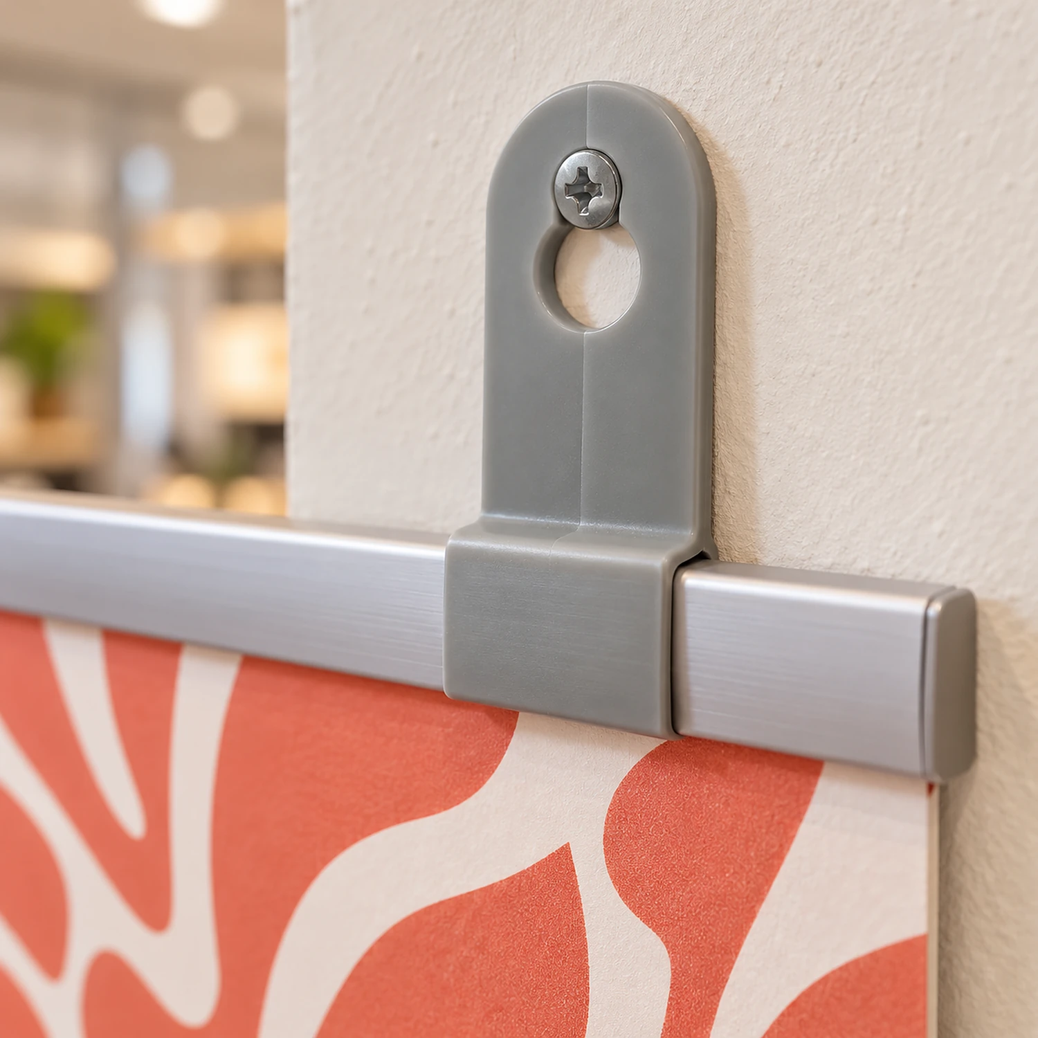 Grey closed hook on a poster rail hanging from a wall screw