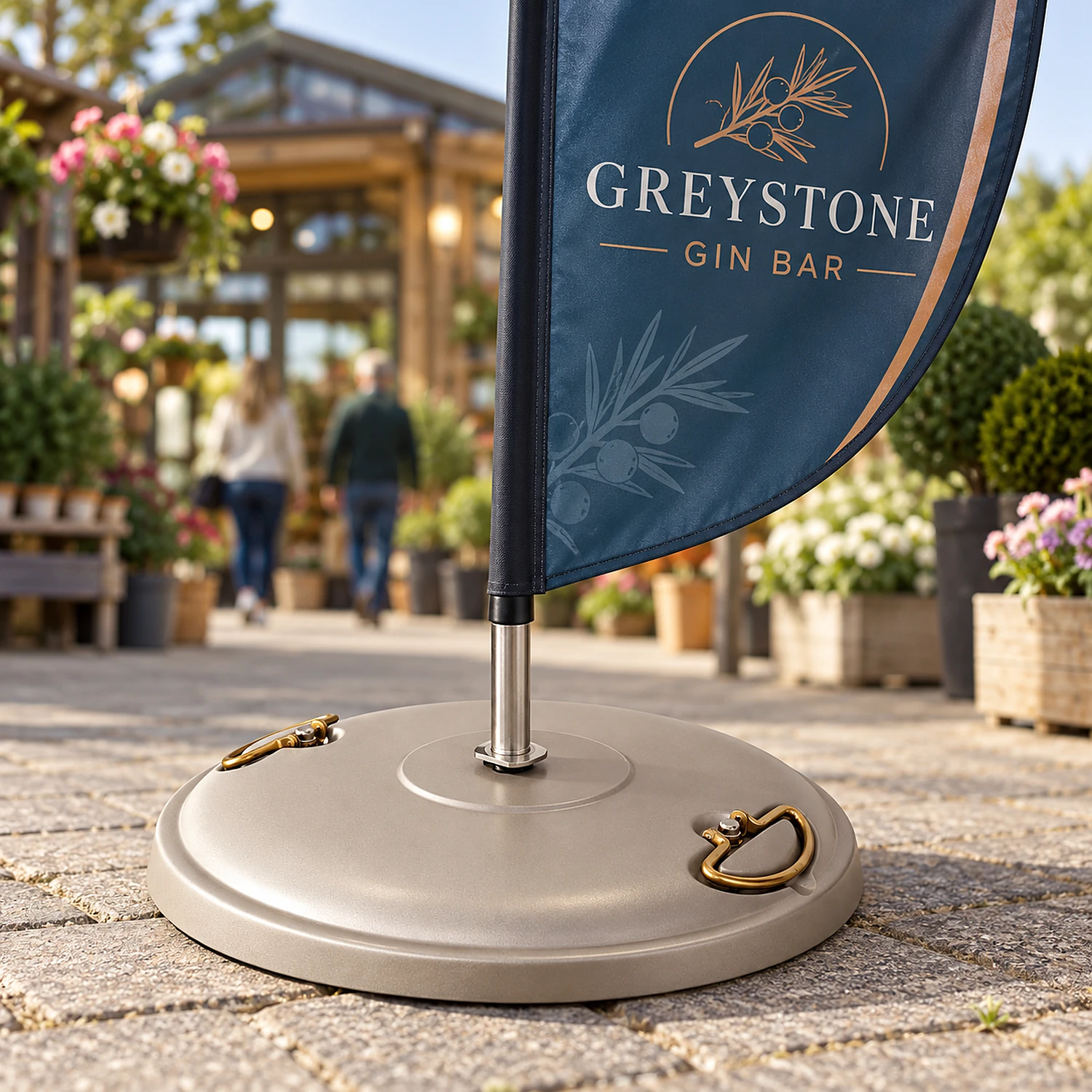 Concrete flag base holding a feather flag at a garden centre entrance