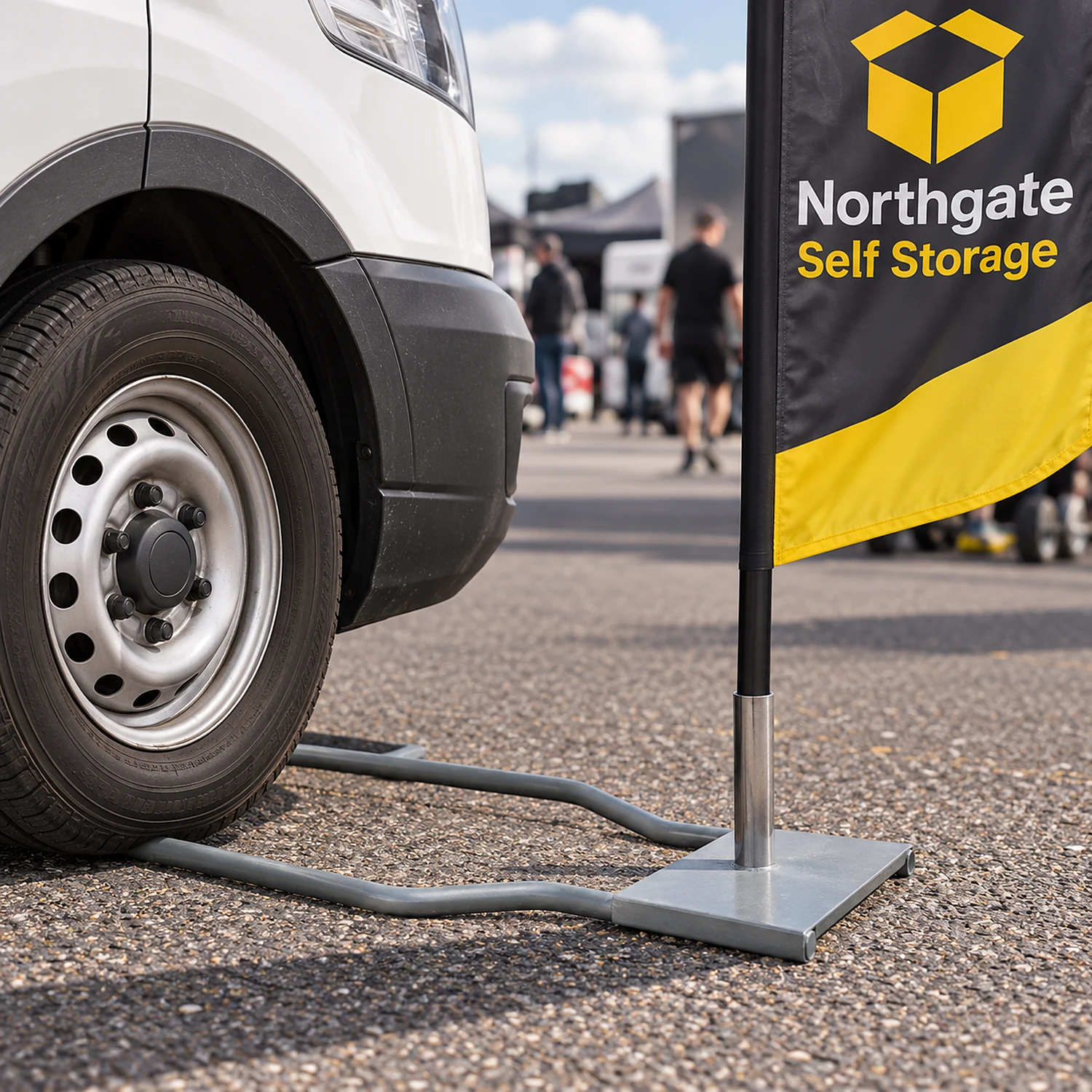 Drive-on car foot held down by a van wheel with a flag in a paddock
