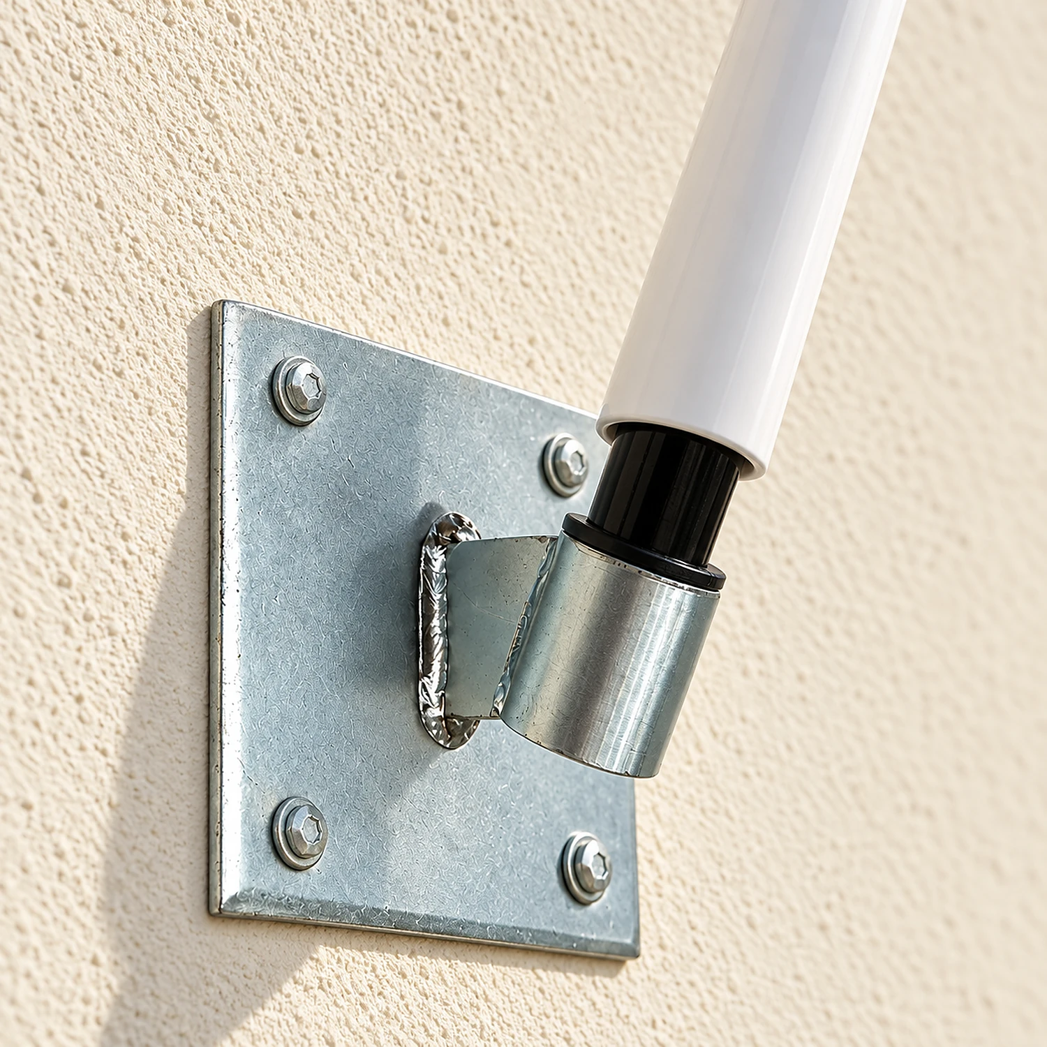 Angled wall mount bolted to a rendered wall with a pole fitted