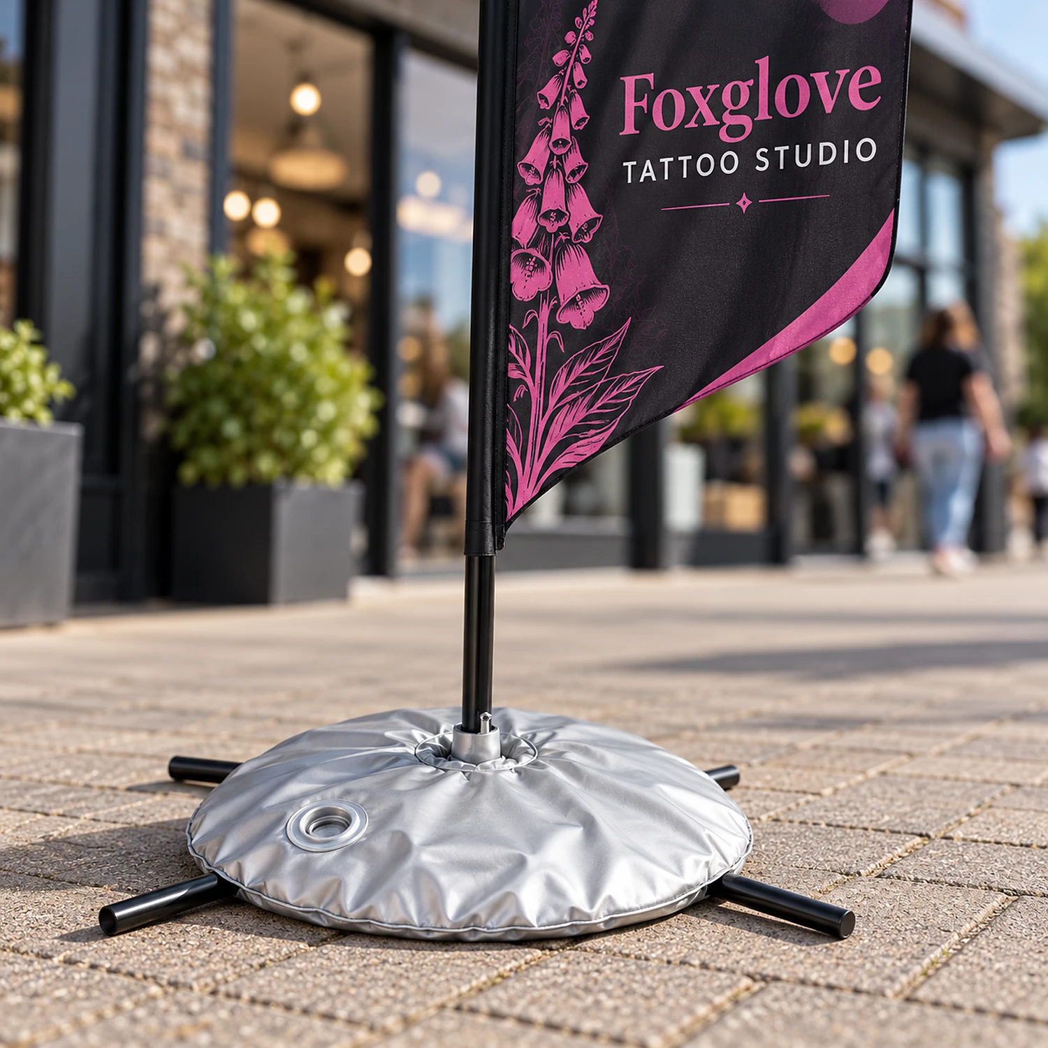 Flag cross base with silver weight bag holding a medium feather flag