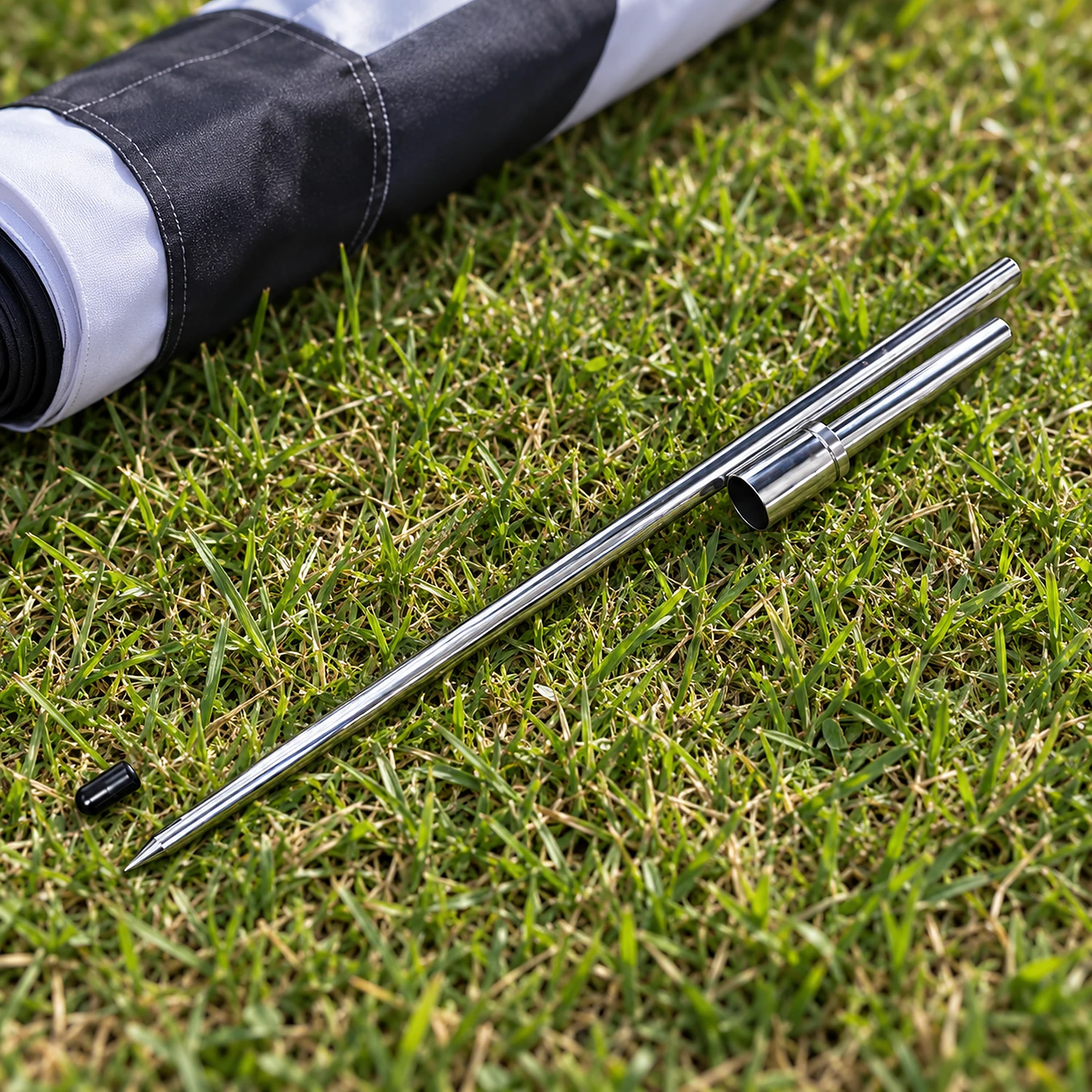 Metal ground spike parts on the grass before set-up