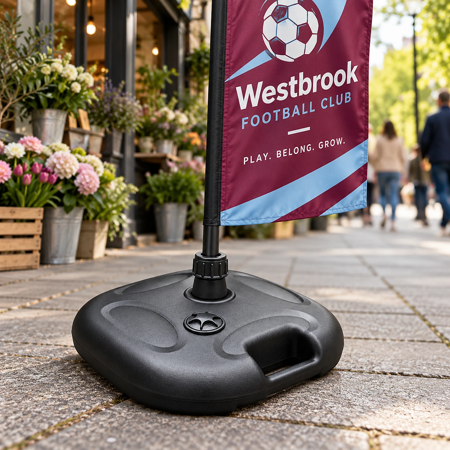 Basic parasol flag base holding a crest flag outside a florist