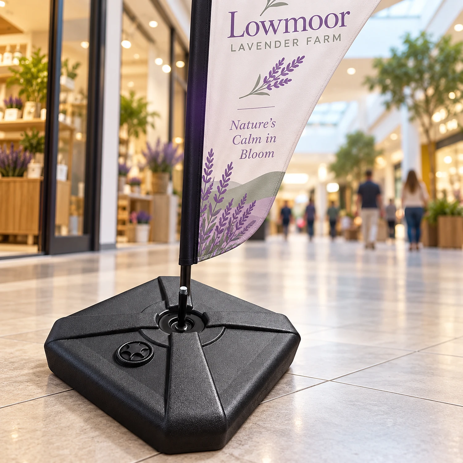 Medium parasol flag base holding a feather flag in a shopping centre