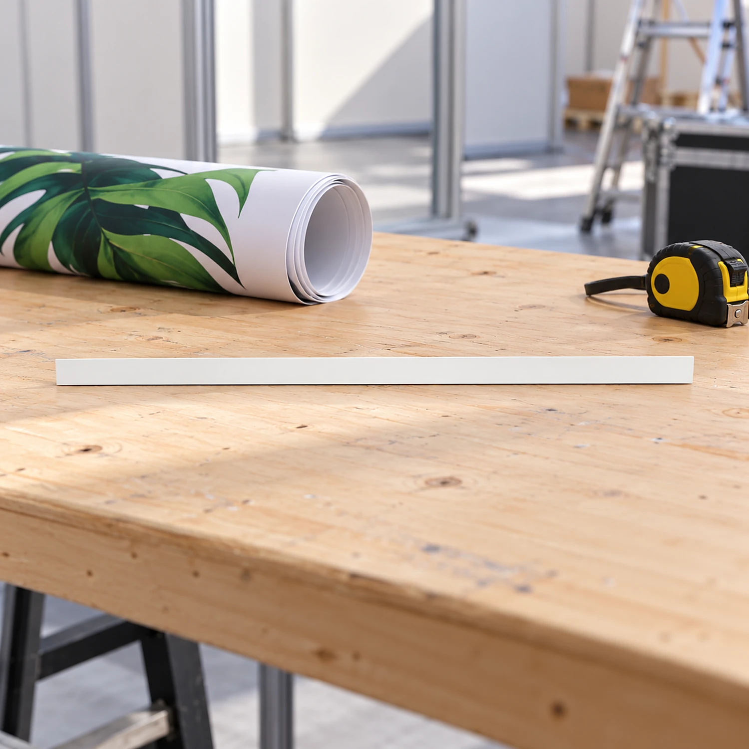 Front straight kicker on a workbench beside a rolled graphic