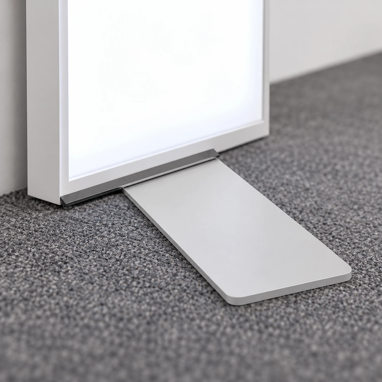 Half foot under a lightbox standing close to a wall