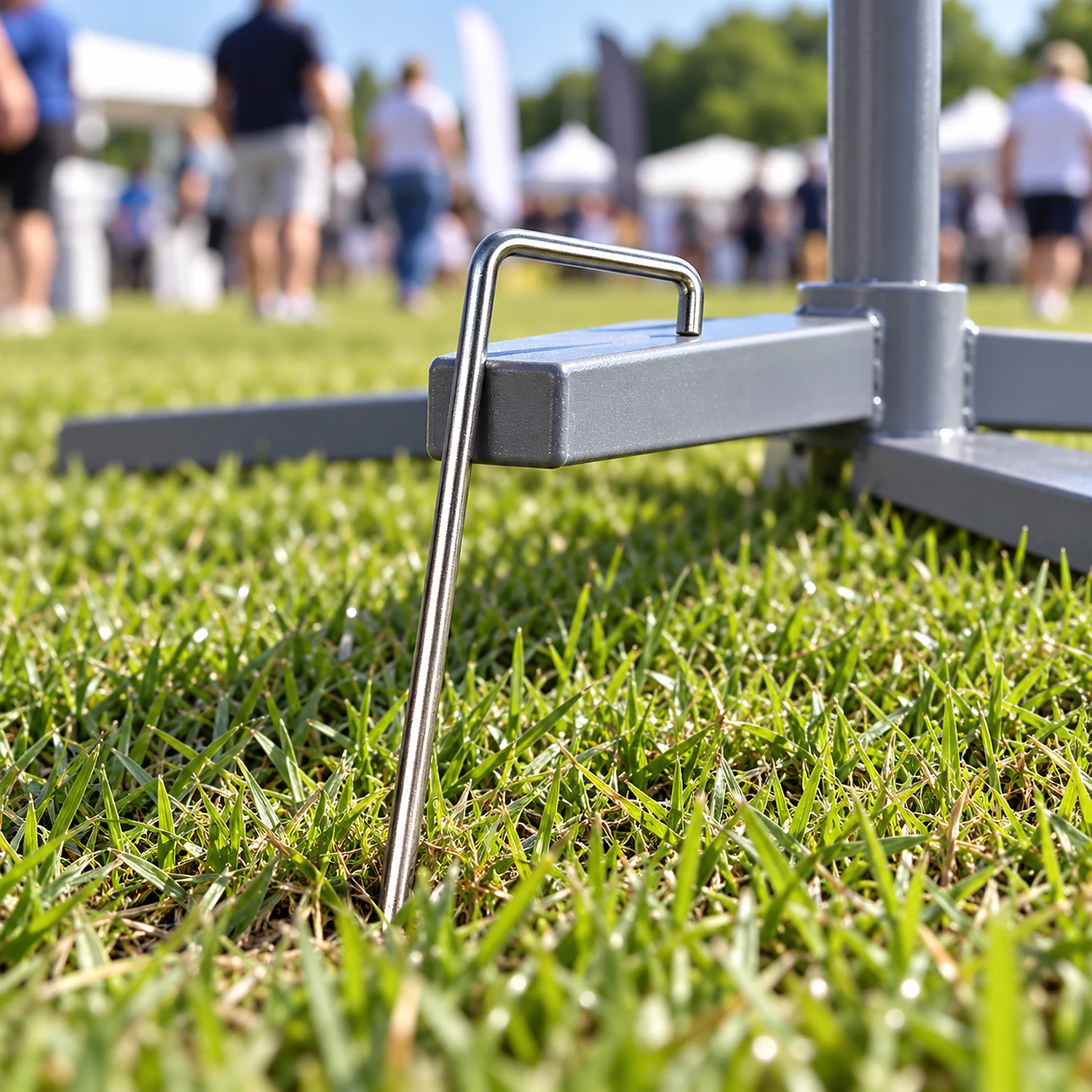Heavy duty ground peg holding down a flag cross base on grass