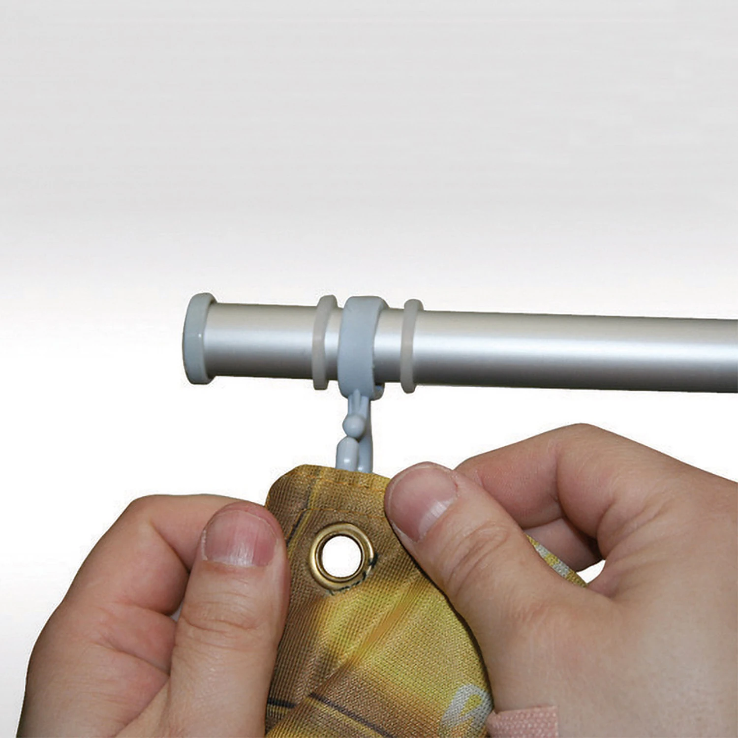 Banner eyelet being hooked onto the ring clips of the frame top pole