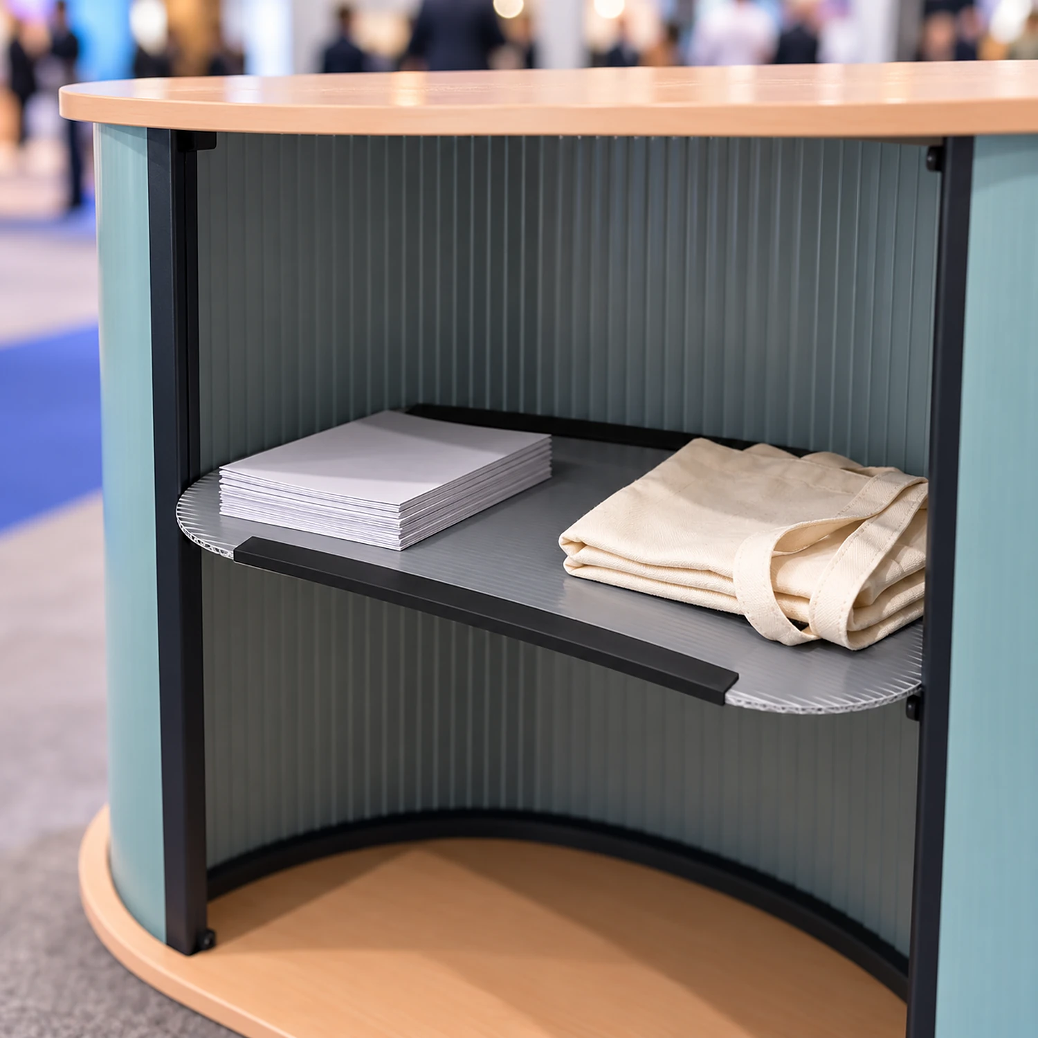 Internal shelf inside a curved counter holding brochures at a trade show