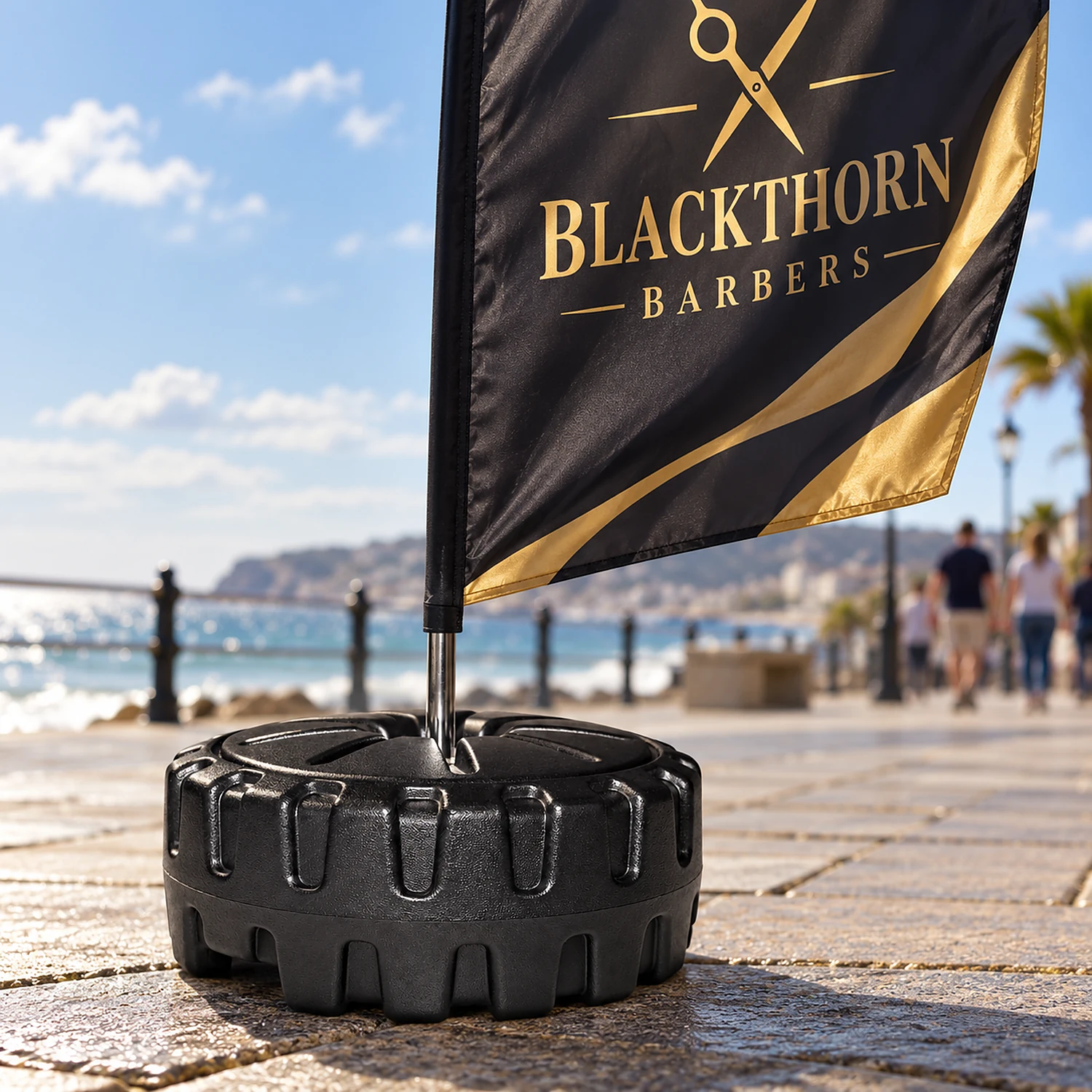 Large water base holding a flag on a seafront promenade