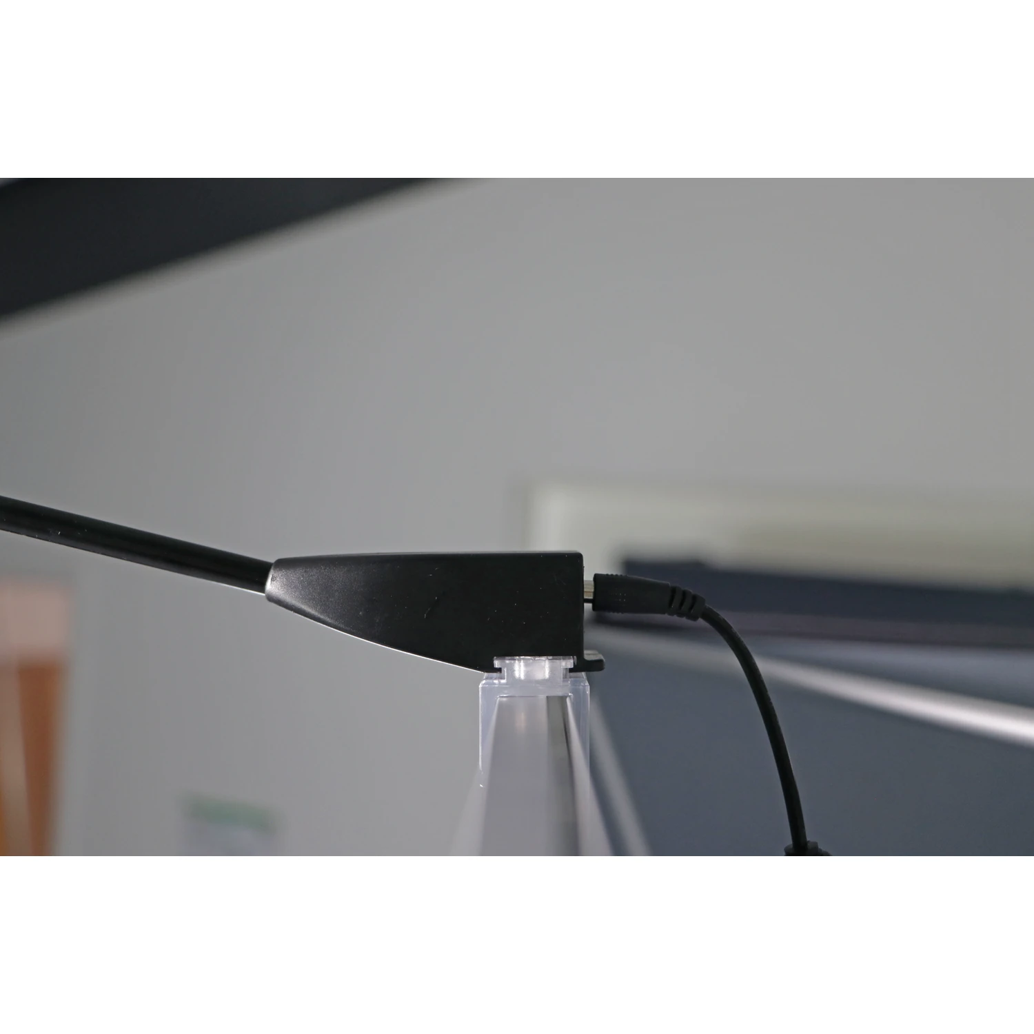 LED spotlight clip and cable on the display edge, side view