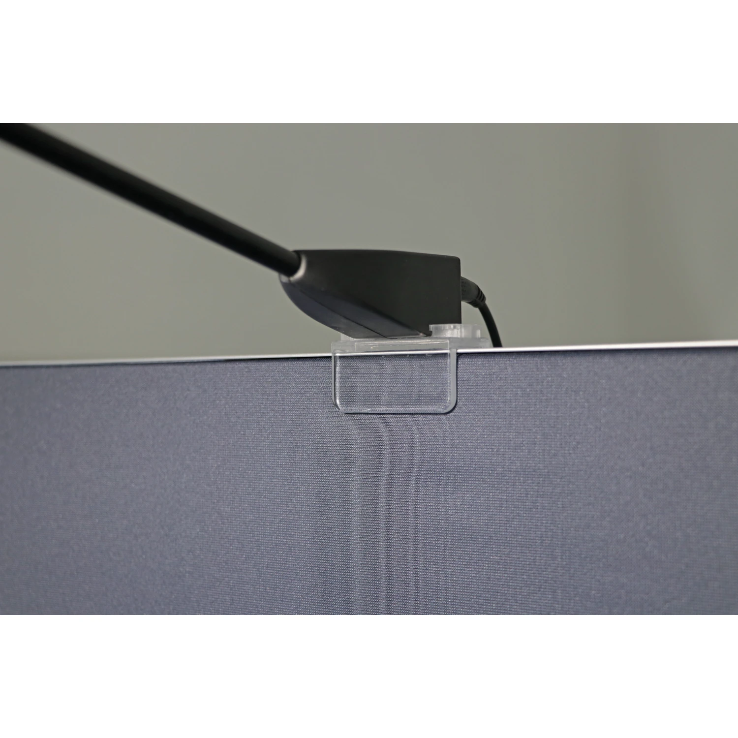 LED spotlight base clipped to the top edge of a fabric pop-up display