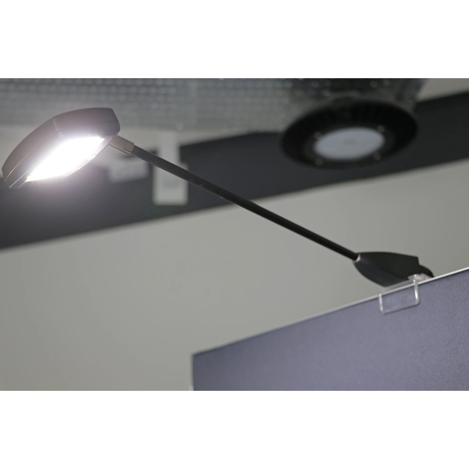 LED spotlight lit on its arm above a fabric pop-up display