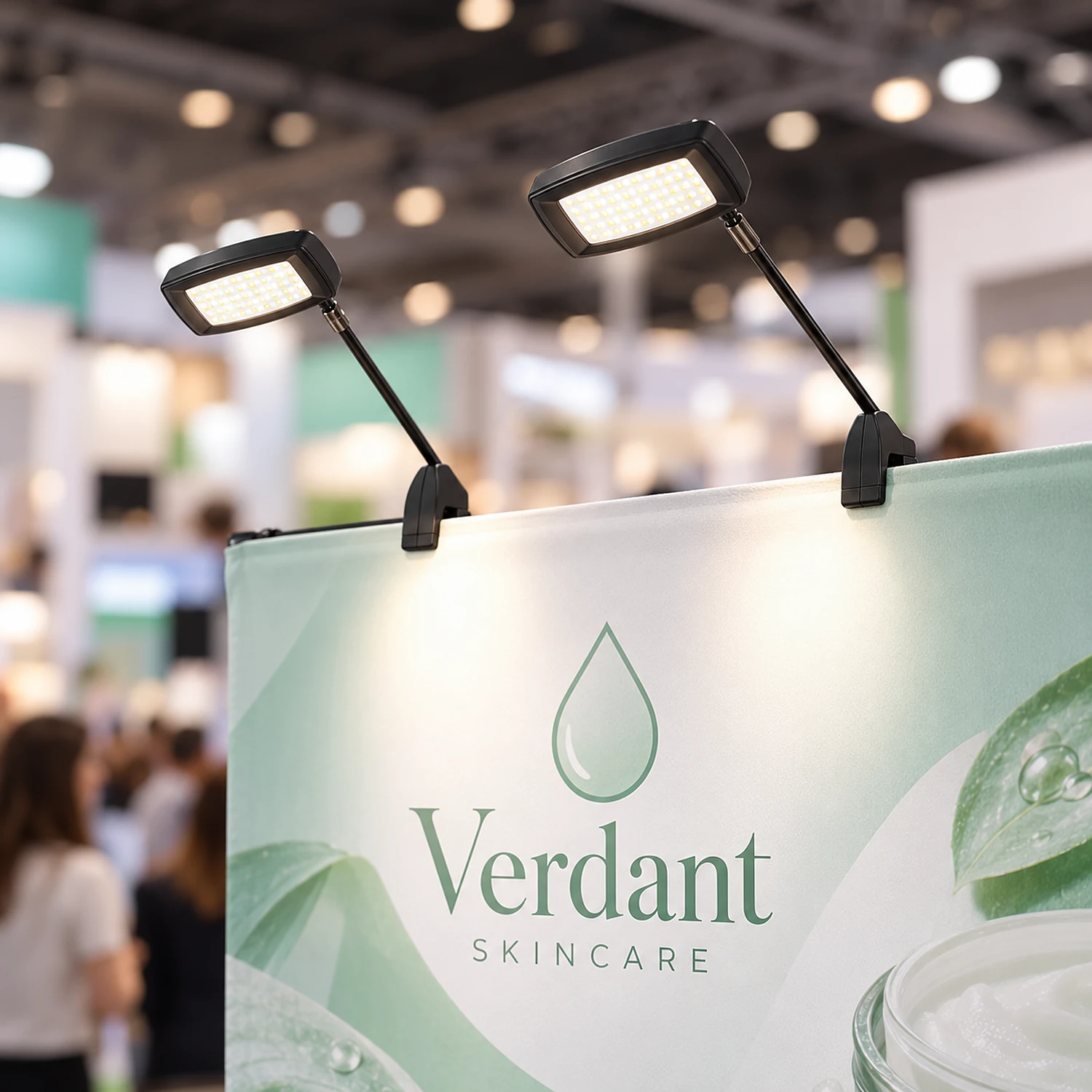 Two LED spotlights lighting a straight pop-up stand at a show