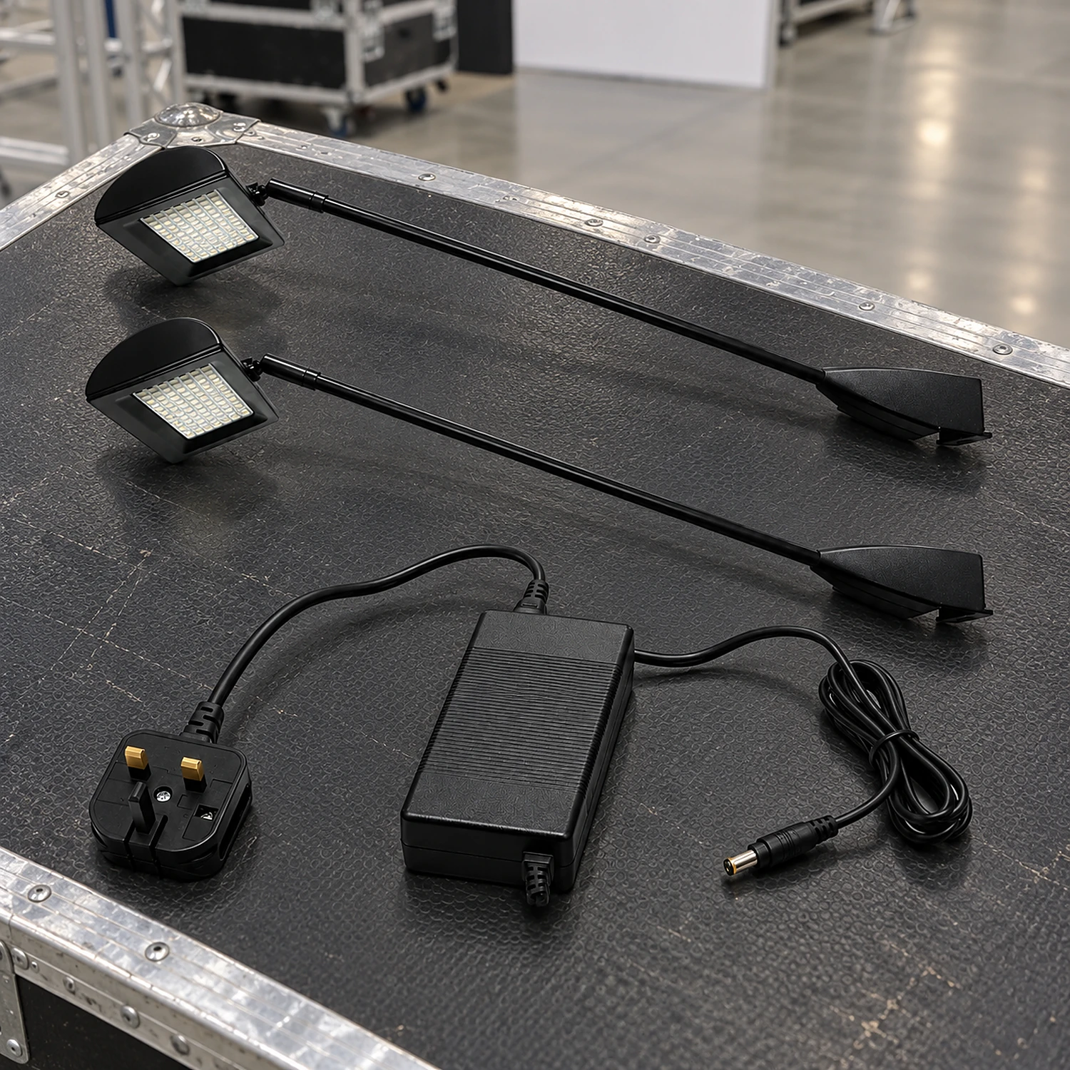 Pair of LED spotlights and power supply on a flight case