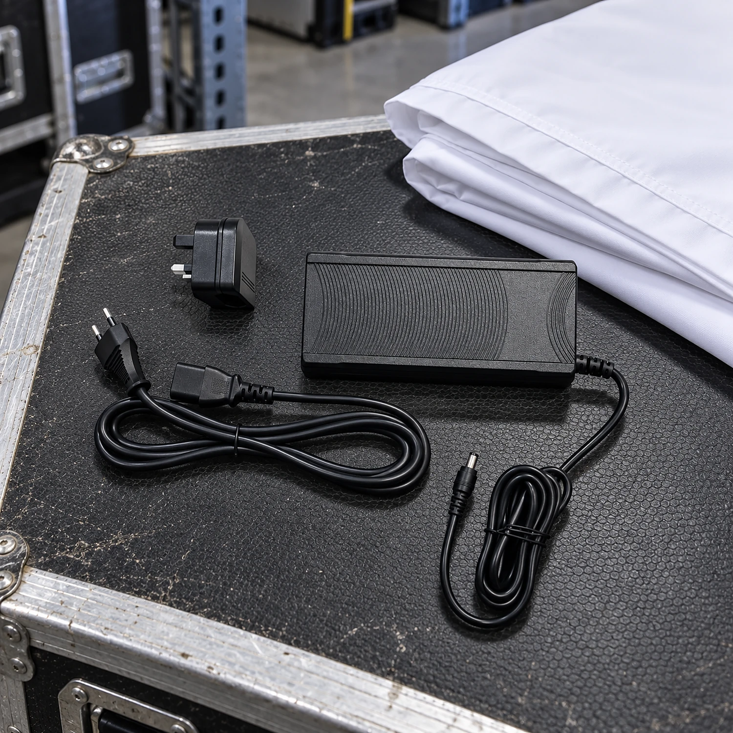 LED power supply on a flight case next to a folded lightbox graphic